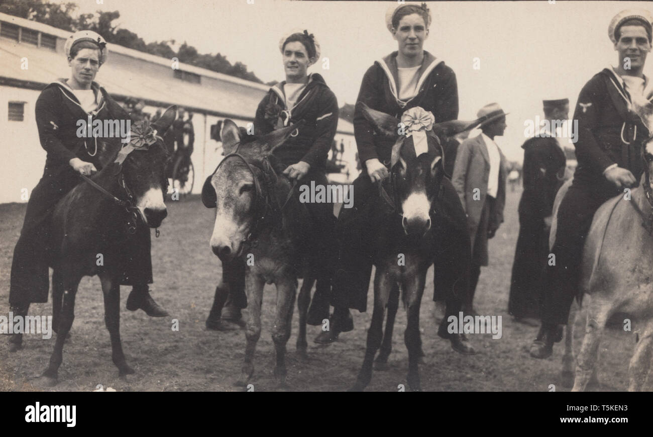 Vintage Photographic Postcard Showing British Royal Navy Sailors Riding Donkeys at Port Elizabeth, South Africa in 1925. Stock Photo