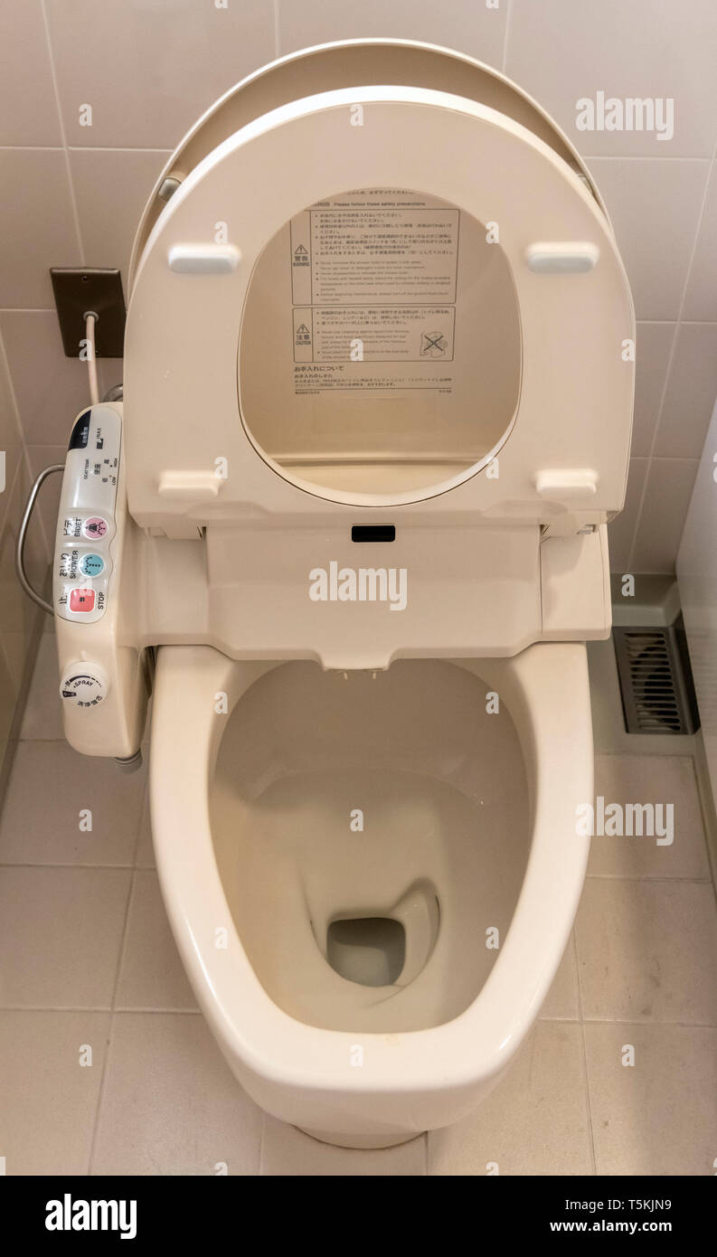 Typical Japanese toilet showing the control panel for built-in bidet, seat warmer etc., Tokyo, Japan Stock Photo