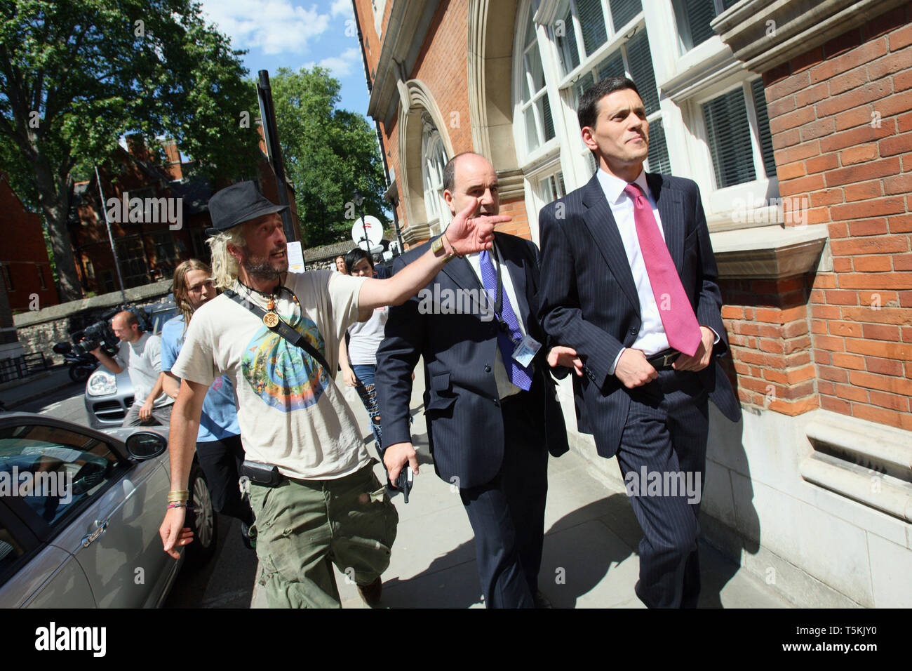 David Miliband MP walking away after he is confronted by an anti war protester. London 22 May 2010. Stock Photo