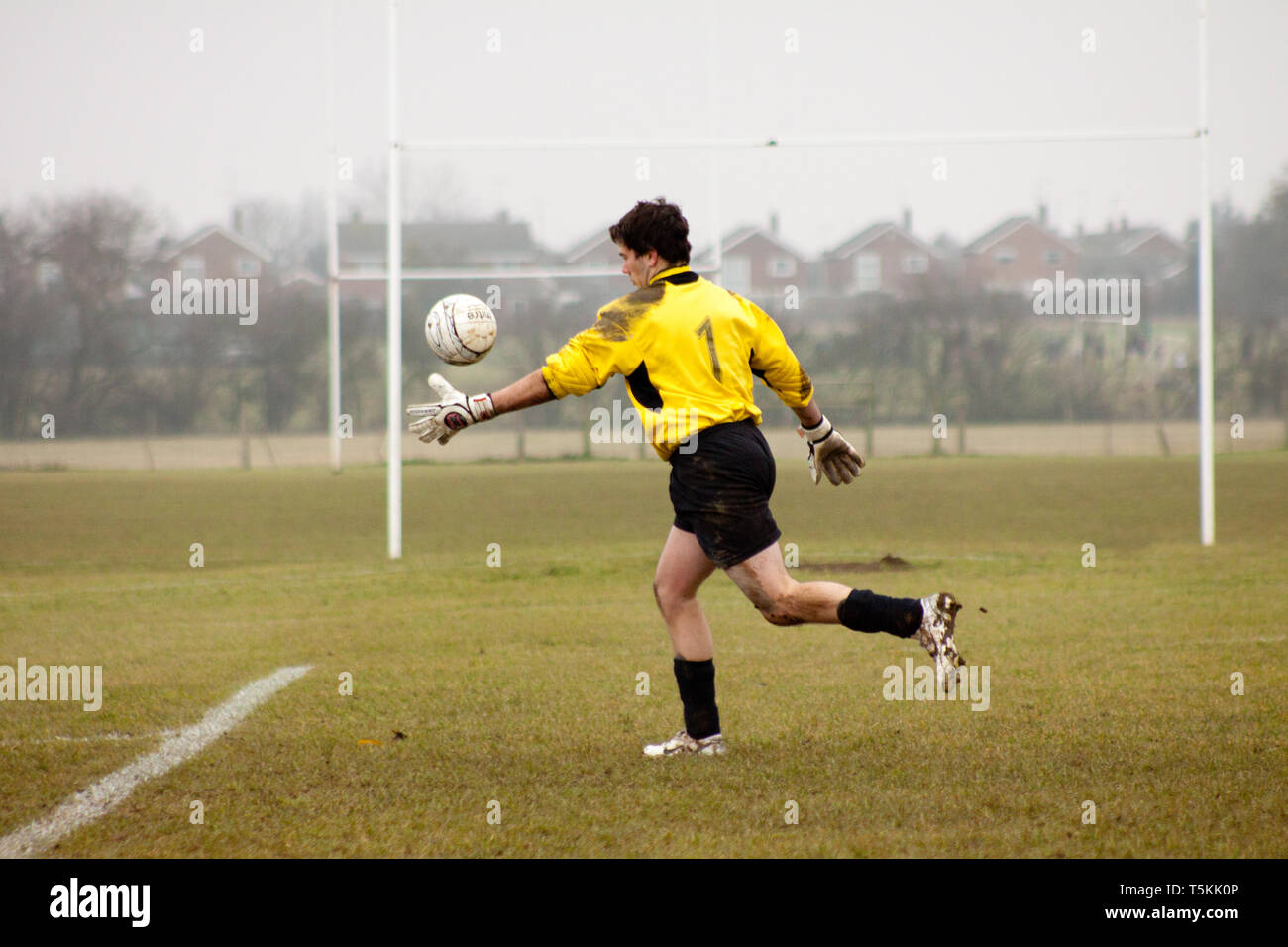 Goalkeeper kicking the ball out of his hands Stock Photo Alamy