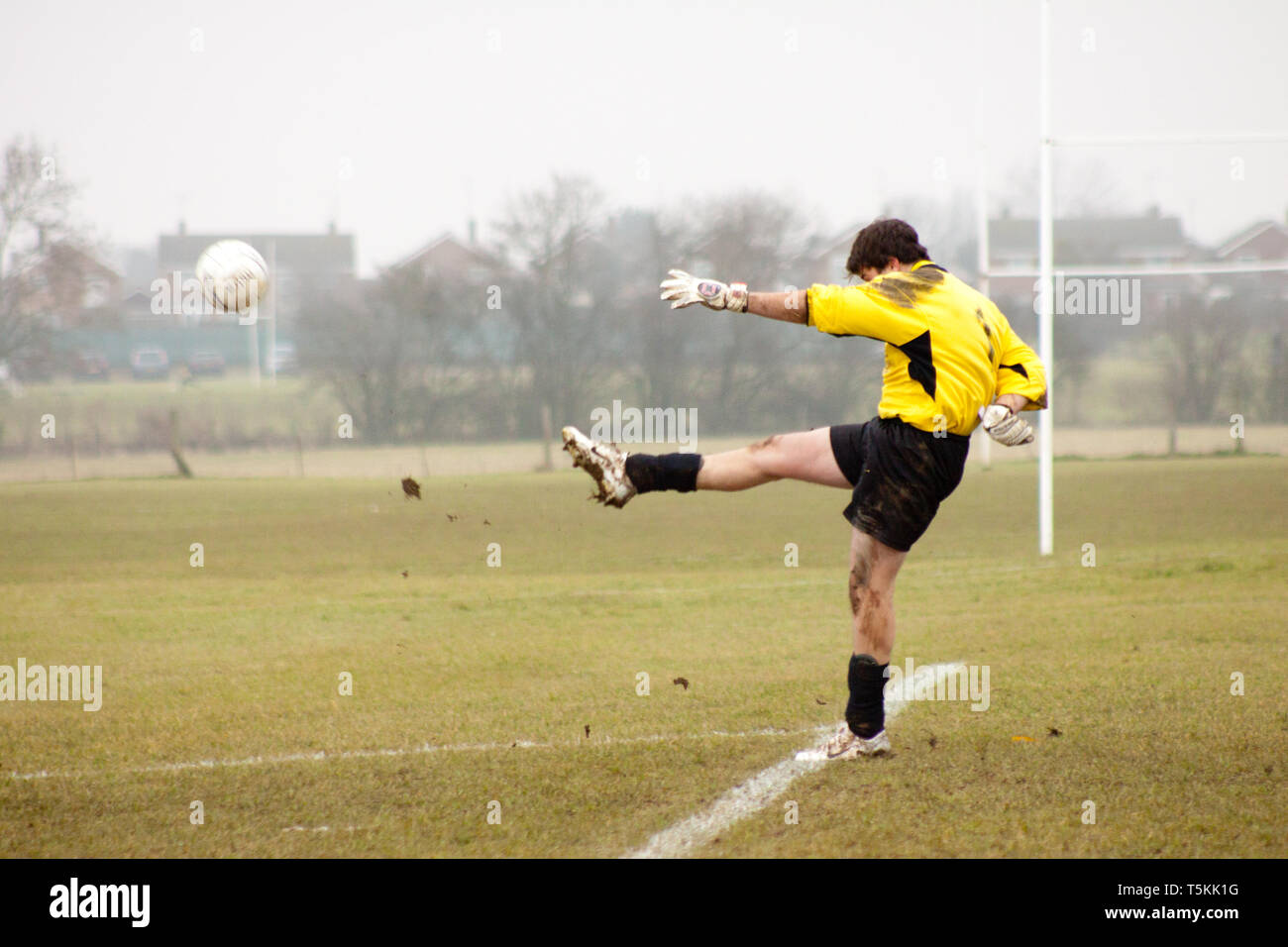 Goalkeeper kicking the ball out of his hands Stock Photo Alamy