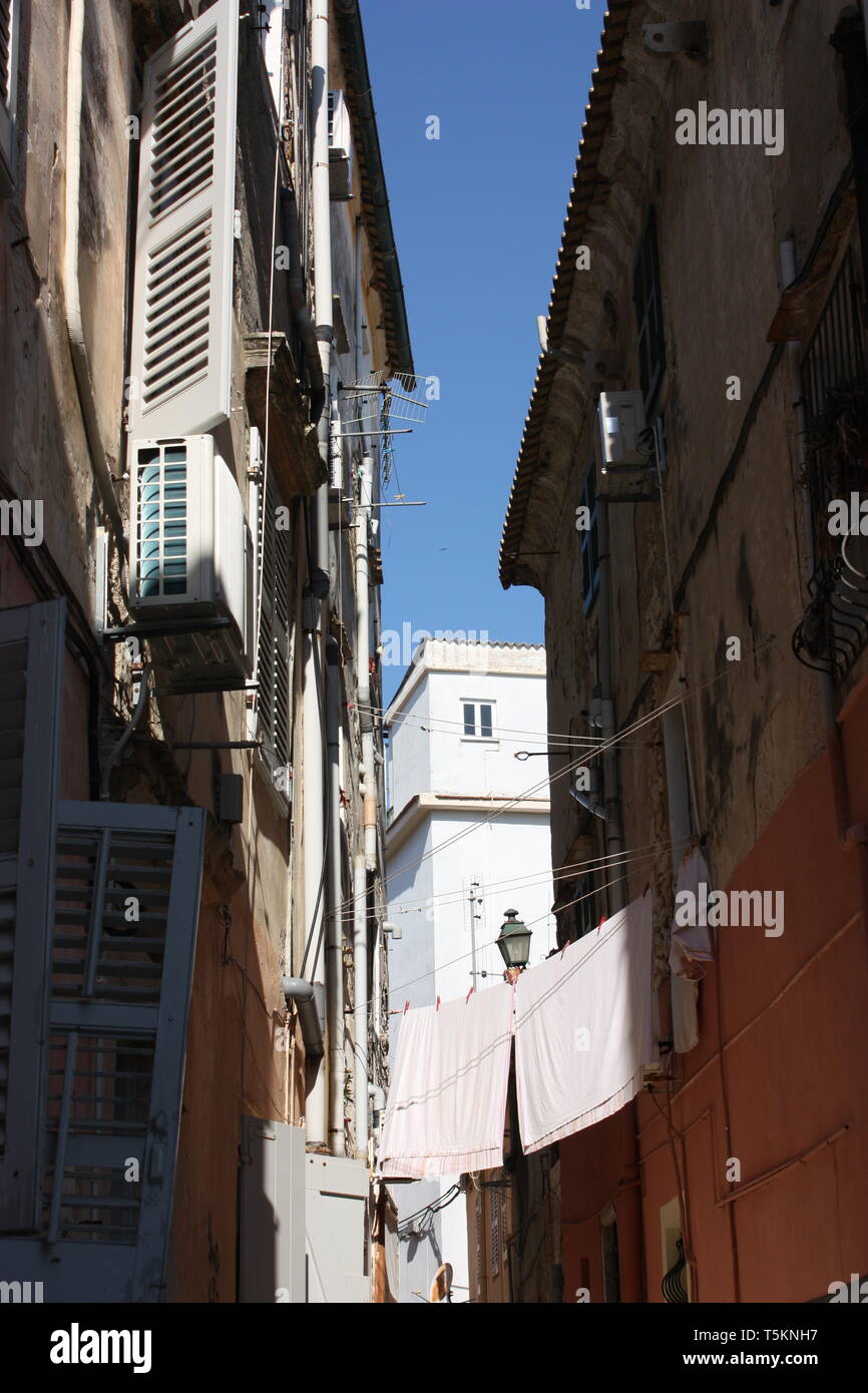 Washing hanging in one of the backstreets of the old town of Corfu, one of the Ionian Islands of Greece. Stock Photo