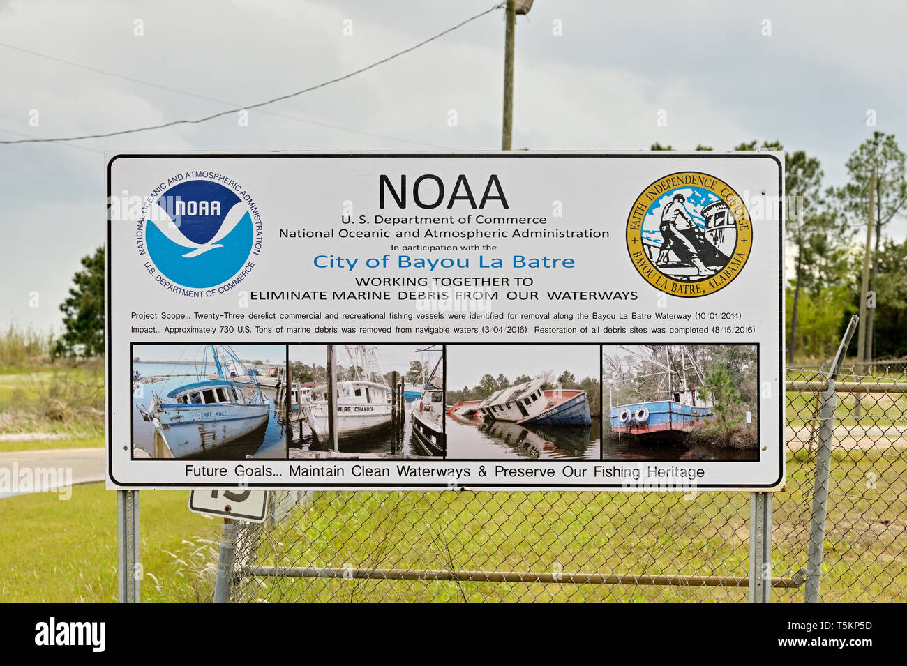 NOAA sign advising conservation to maintain clean waterways and keep marine debris out of the bayou and Mobile Bay, in Bayou La Batre Alabama, USA. Stock Photo