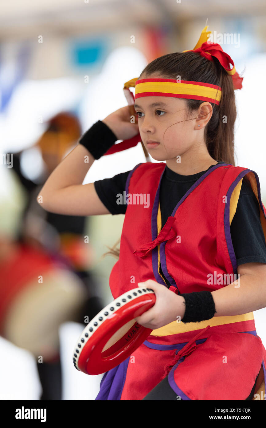 Wilmington, North Carolina, USA - April 6, 2019: The North Carolina Azalea Festival, Girl member of the Ruikyukoku Matsuri Daiko performing drum dance Stock Photo