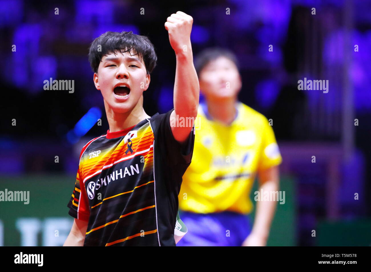 Budapest. 25th Apr, 2019. An Jaehyun of South Korea celebrates victory  while Harimoto Tomokazu of Japan leaving the court after the men's singles  round of 16 match at 2019 ITTF World Table