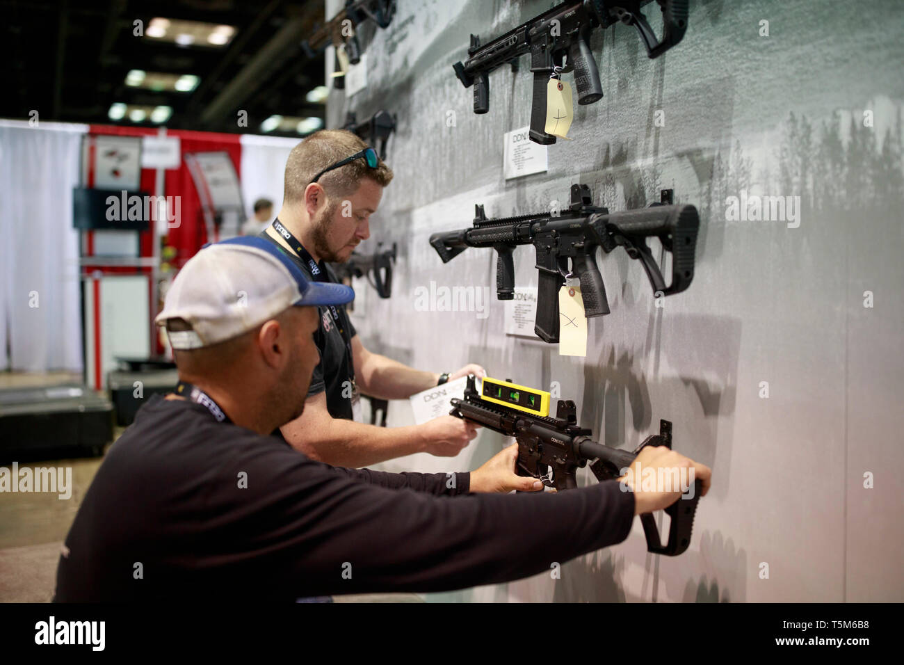 Workers prepare the Daniel Defense booth. Vendors prepare booths in the