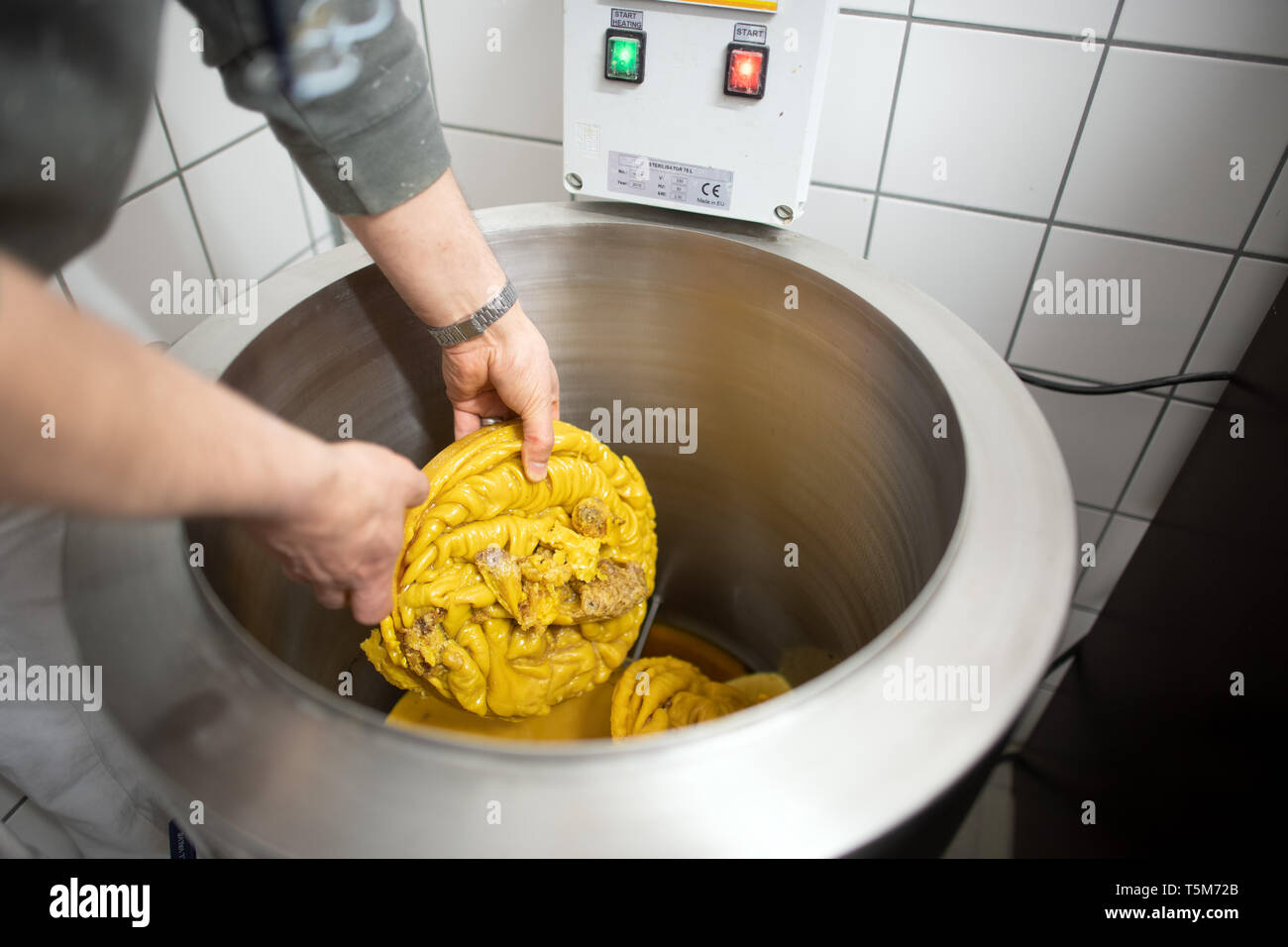 Remscheid, Germany. 10th Apr, 2019. A prisoner is processing wax to heat it. In NRW, prisoners become active in the fight against bee mortality. Even tough boys learn to take responsibility in dealing with 'Maja' and her friends. In the Remscheid prison they look after around 3 million bees, carpenter bee houses and sell honey. (to dpa 'prison bees' teach prisoners patience: 'One mistake, one sting') Credit: Federico Gambarini/dpa/Alamy Live News Stock Photo