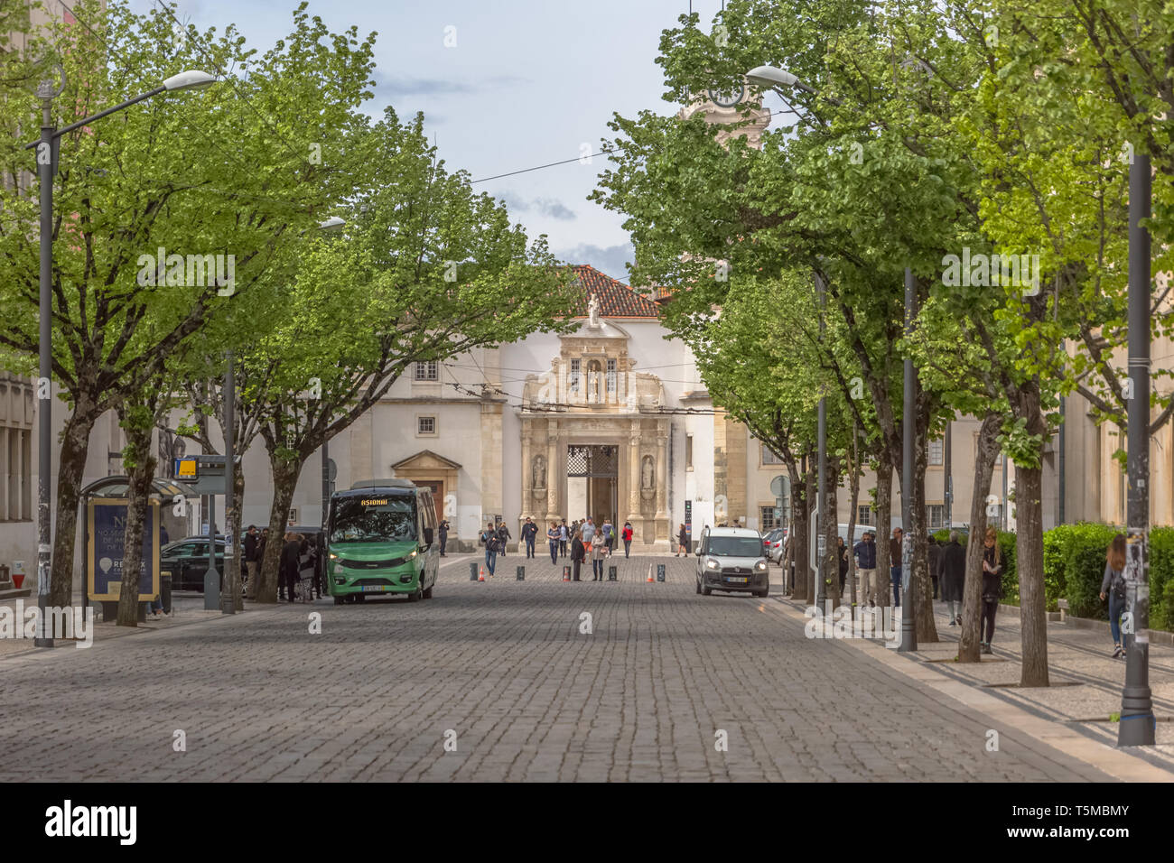 Coimbra / Portugal - 04 04 2019 : View of a plaza, with iron gate of the University of Coimbra, classic architectural structure with masonry, with peo Stock Photo