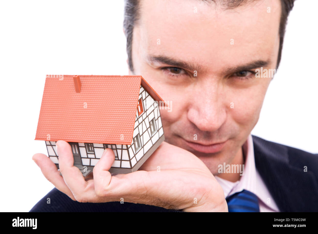 Real estate concept with a businessman holding a mini house Stock Photo ...