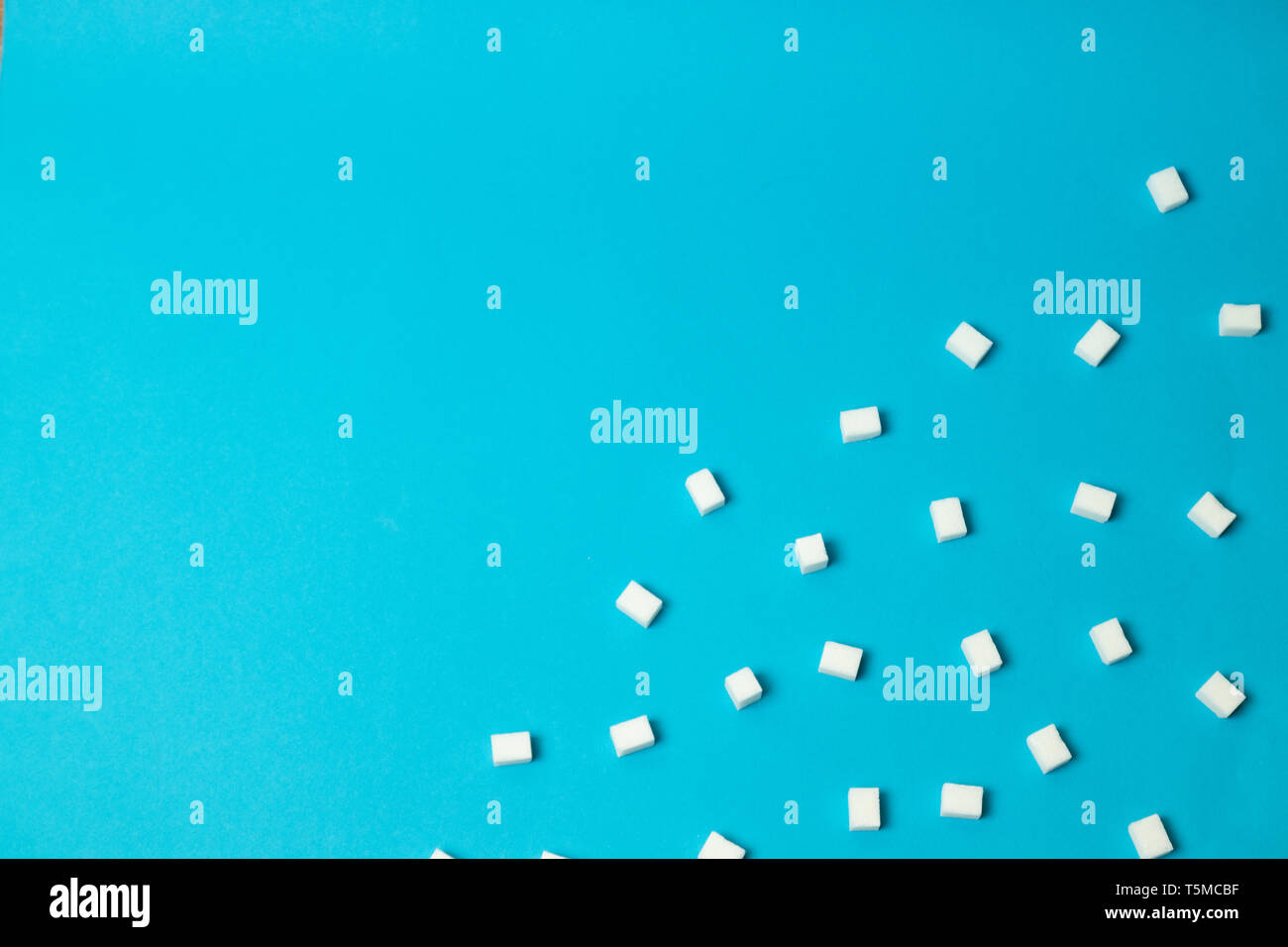Refined sugar cubes on blue background, top view Stock Photo