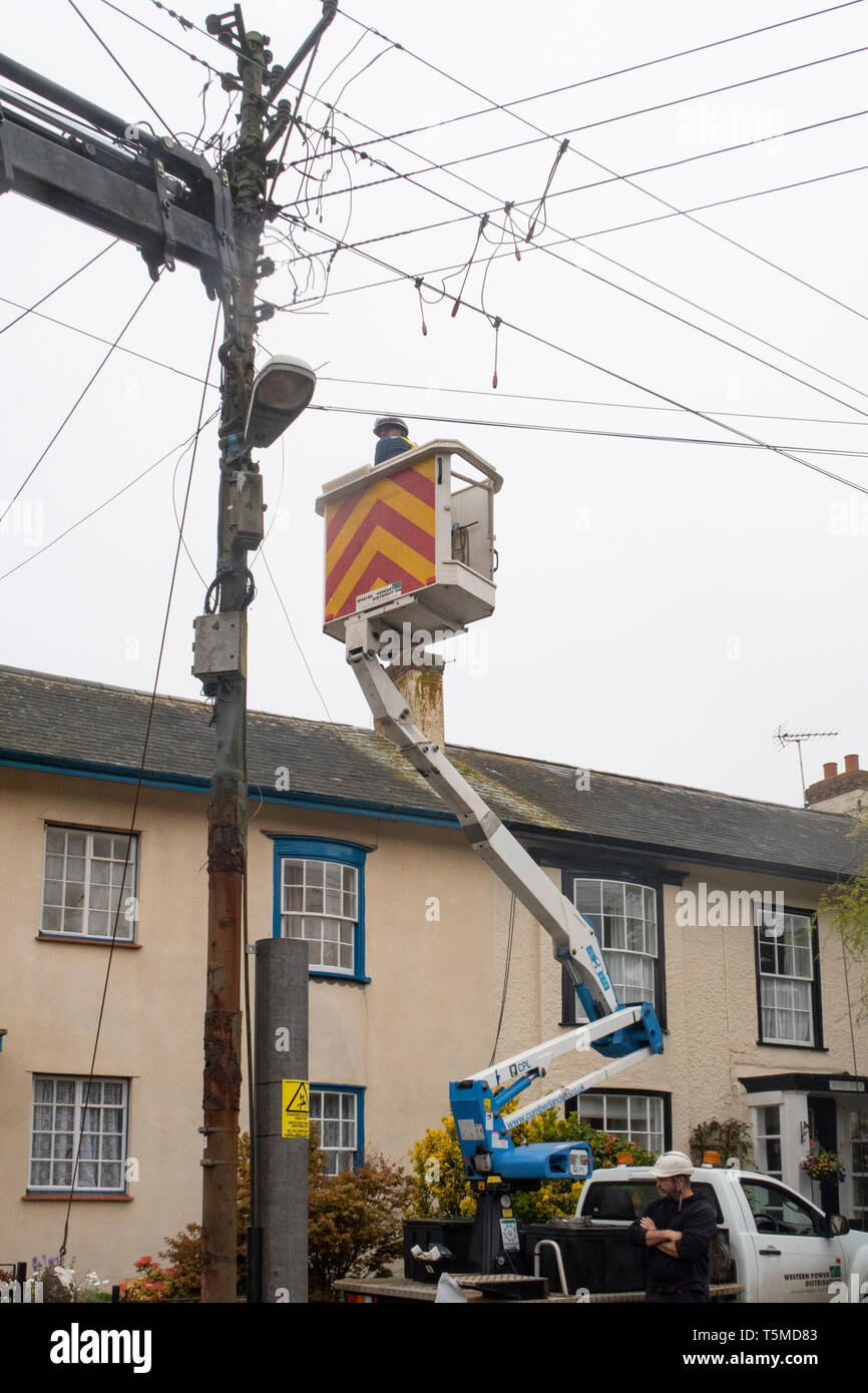 Workers for Western Power Distribution working to replace telegraph poles and electricity cables in Sidmouth, Devon, UK Stock Photo