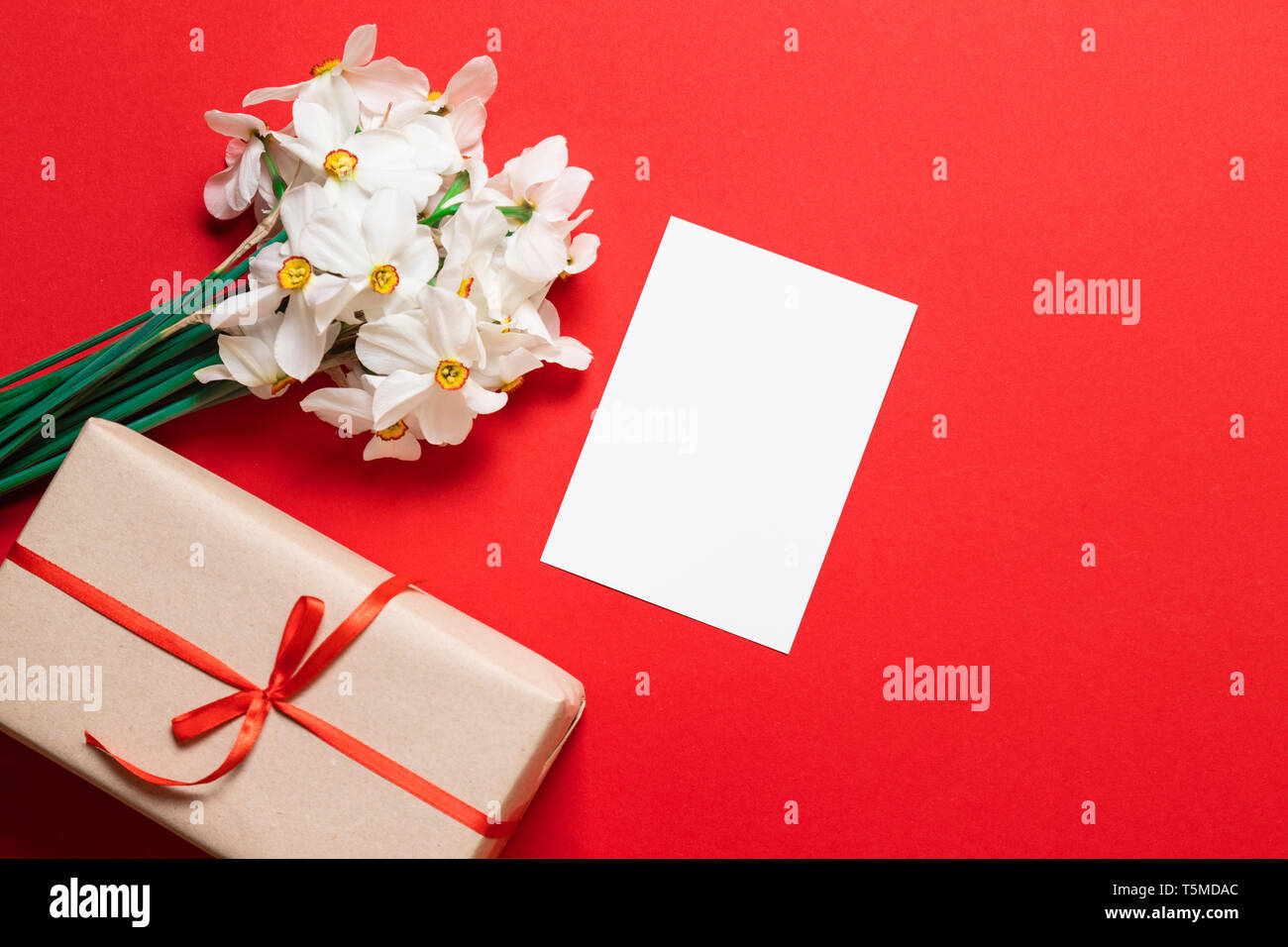 Download Bouquet Of Daffodils Gift Wrapping And A Sheet Of Paper Mockup With Space For Text Stock Photo Alamy