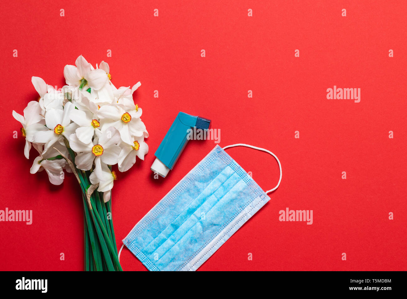 Bouquet of flowers and asthma spray with copy space. Health problems