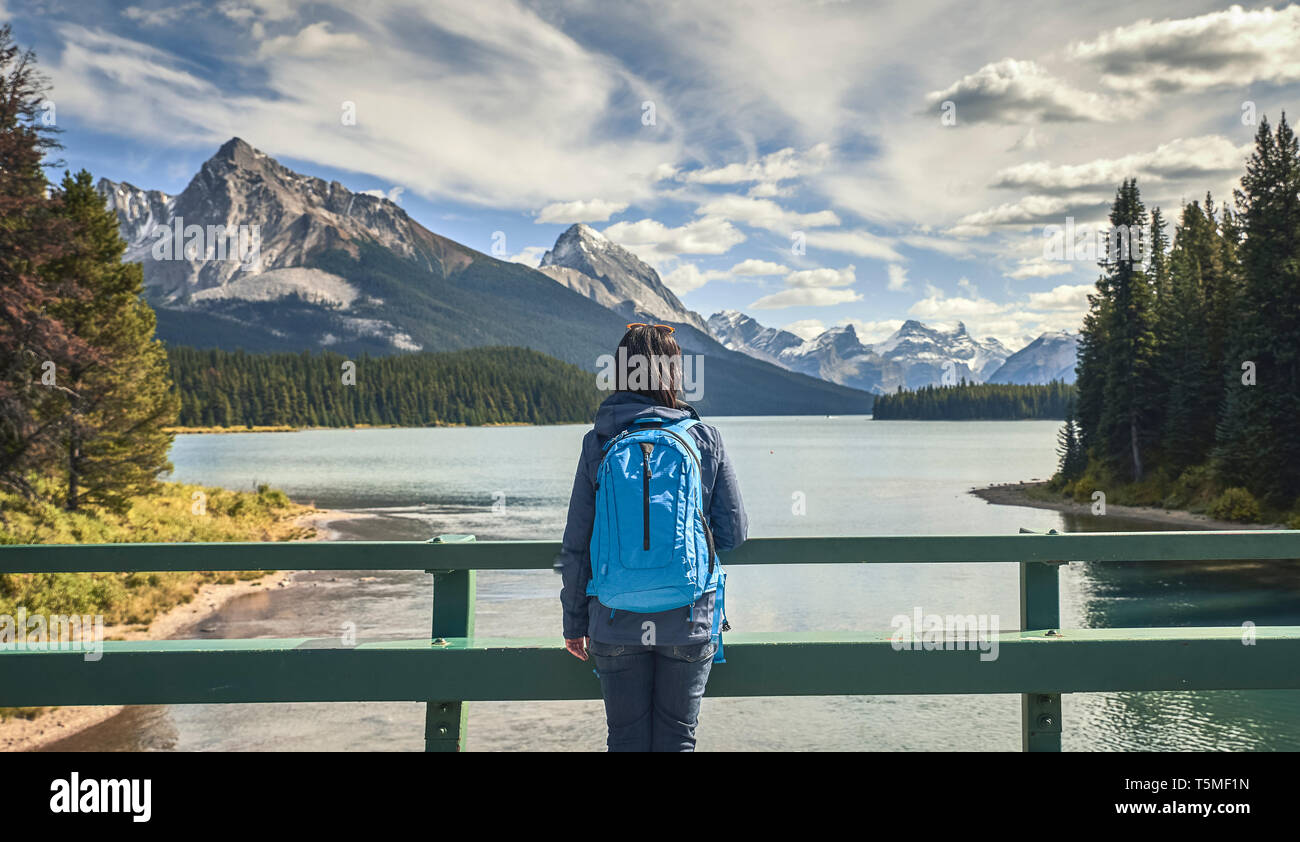 woman looking  by lake at Maligne Lake in Jasper National Park Stock Photo