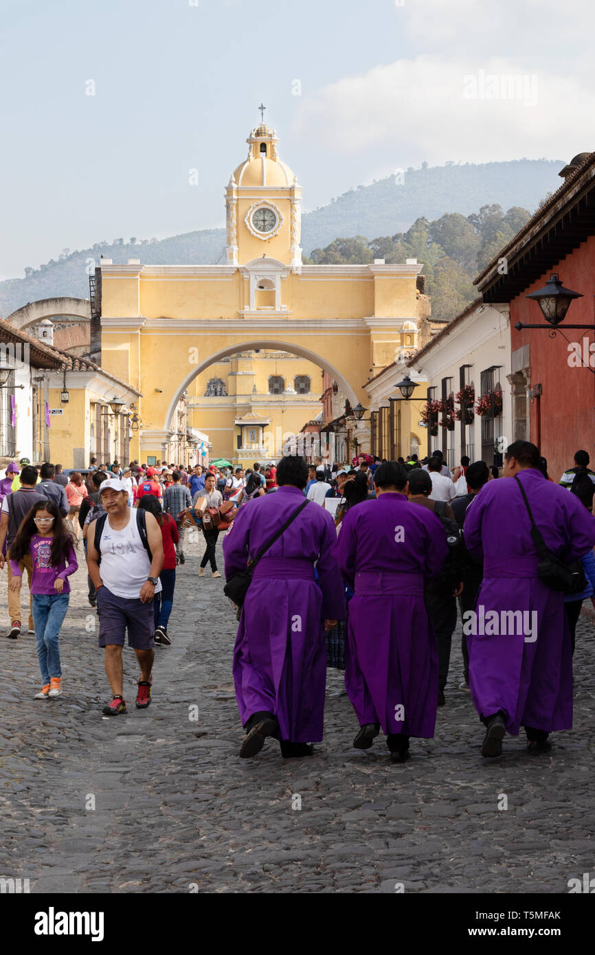 Antigua Guatemala UNESCO world heritage site - local people during holy week in the street, with Santa Catalina arch, Antigua Guatemala Latin America Stock Photo