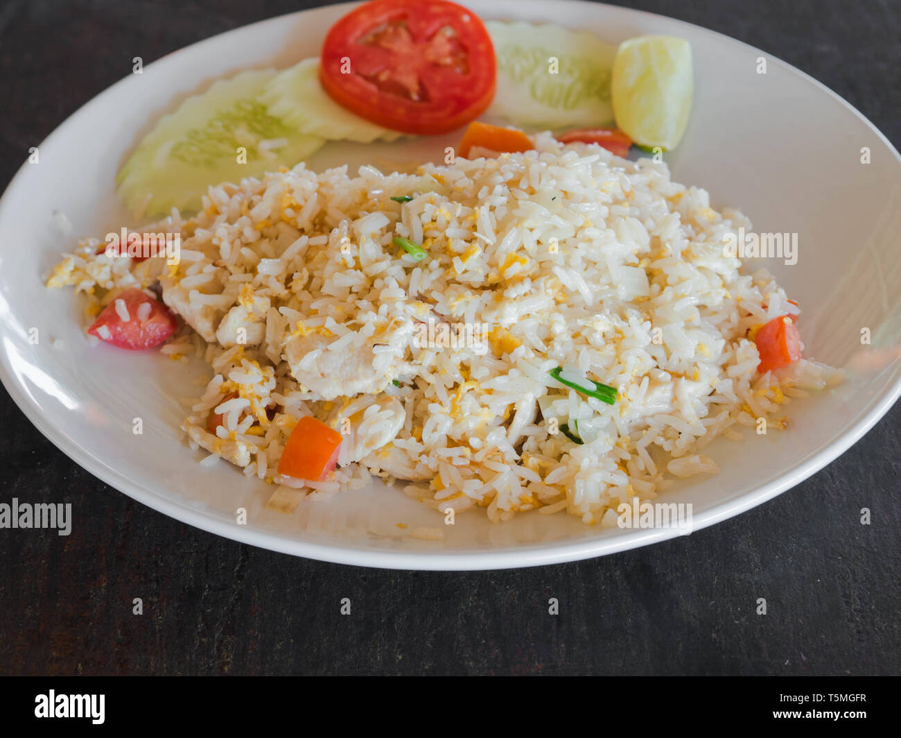 Dish of Asian cuisine - fried white rice with egg, chicken meat and ...