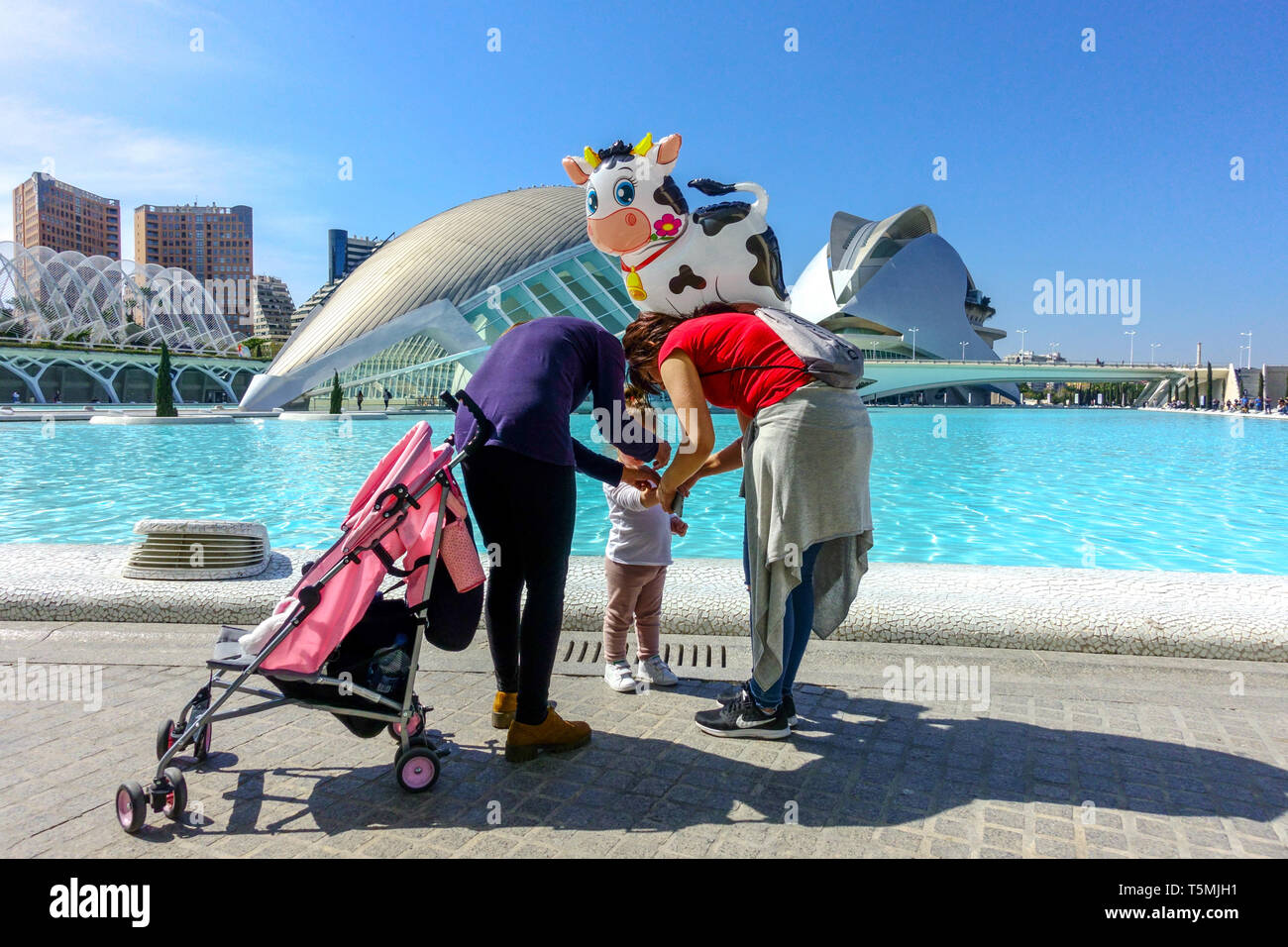 Valencia City Spain Two women, toddler and inflatable balloon cow on  walk-in Valencia City Arts of Sciences Spain Europe everyday life in modern city Stock Photo