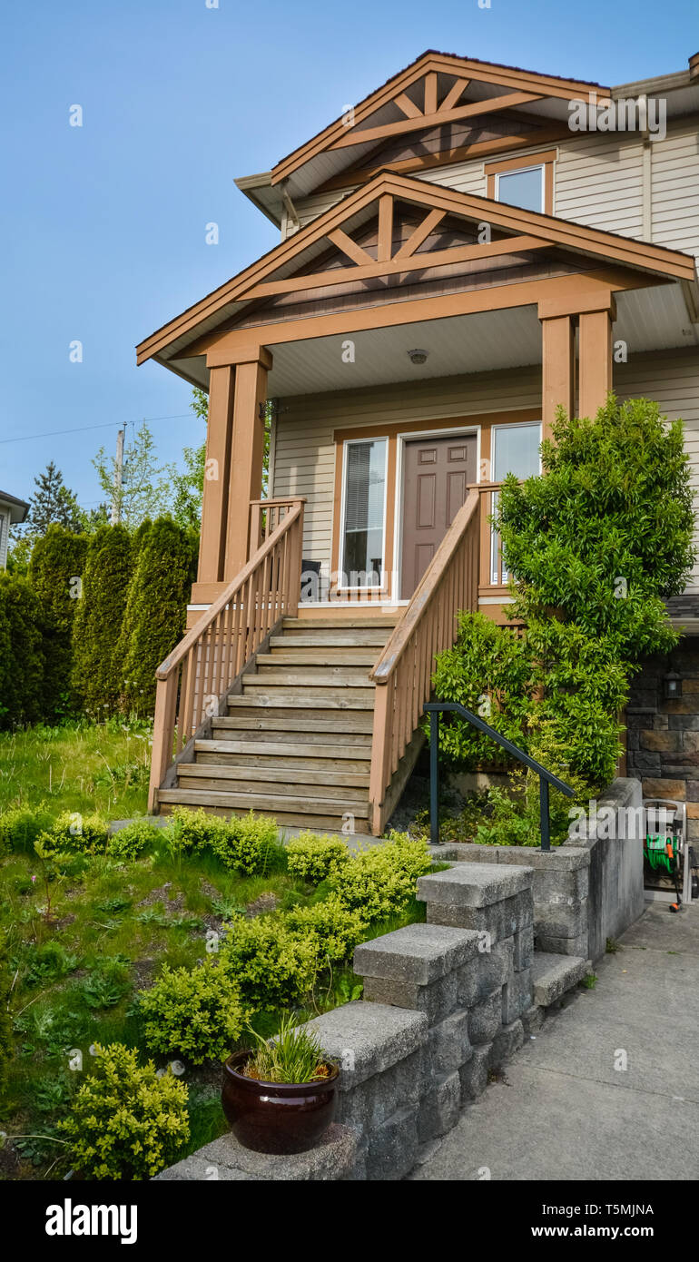 Main entrance of residential house with concrete pavement and doorsteps