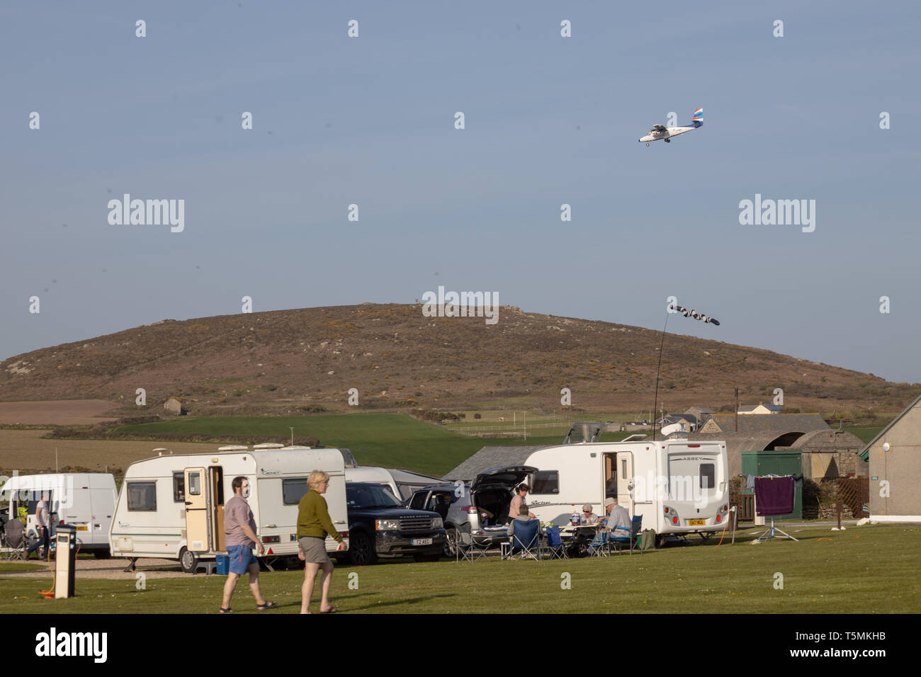 Plane landing at Lands End Airport over Sennan Cove, The Camping and Caravan Club Stock Photo