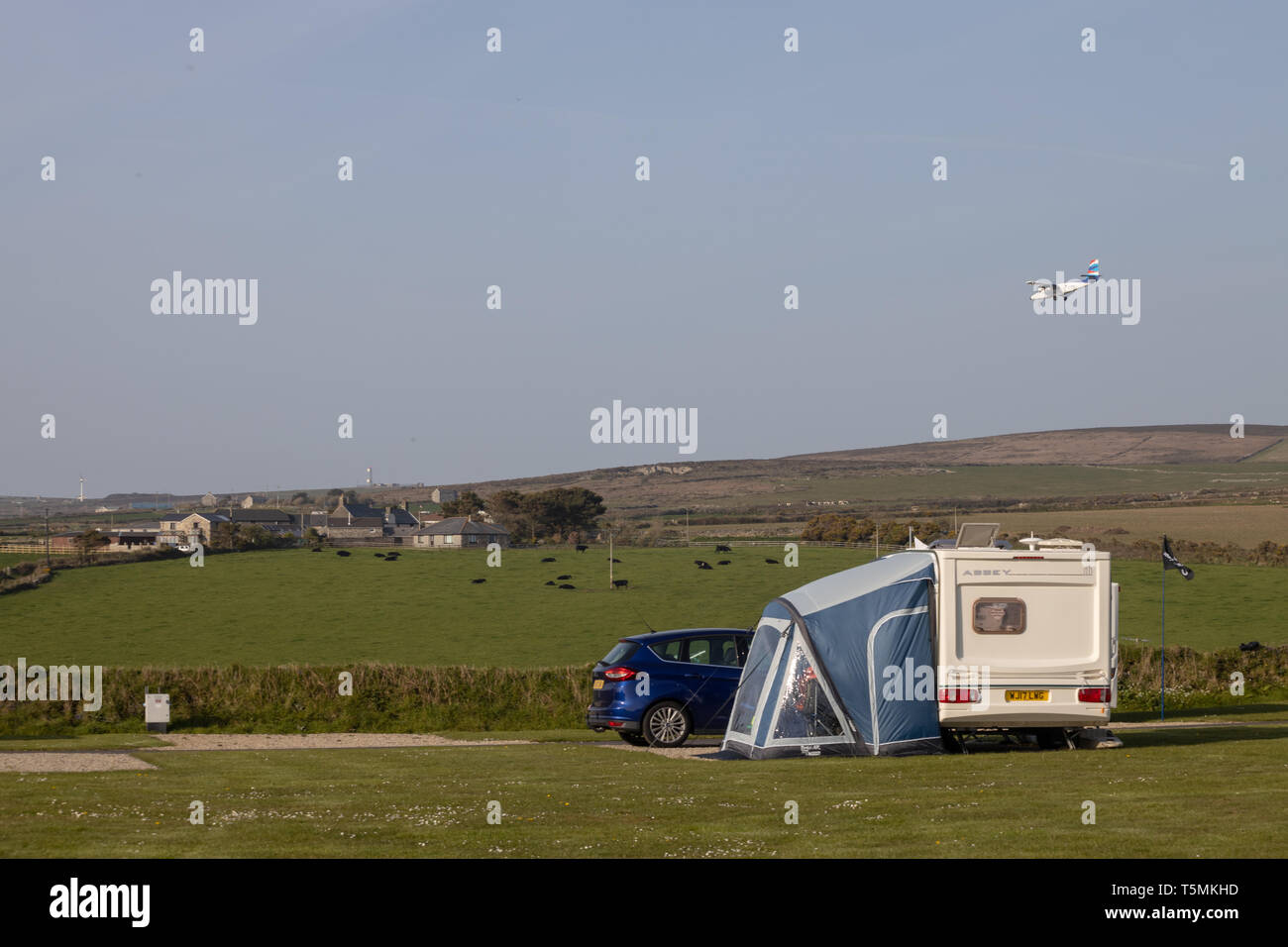 Plane landing at Lands End Airport over Sennan Cove, The Camping and Caravan Club Stock Photo