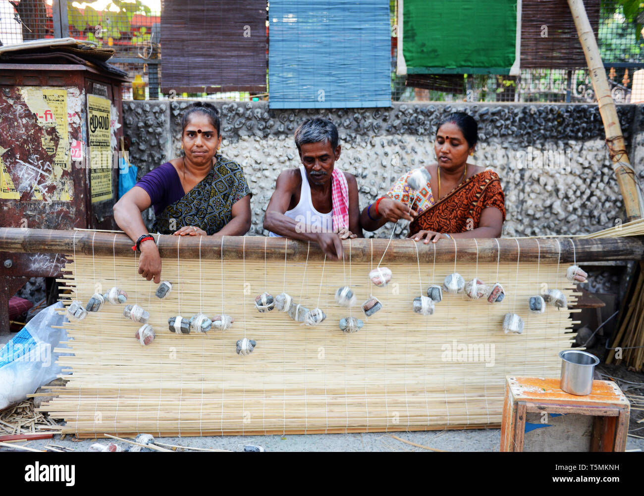 Tamil men and women working on a new bamboo curtain in the streets of Chennai. Stock Photo