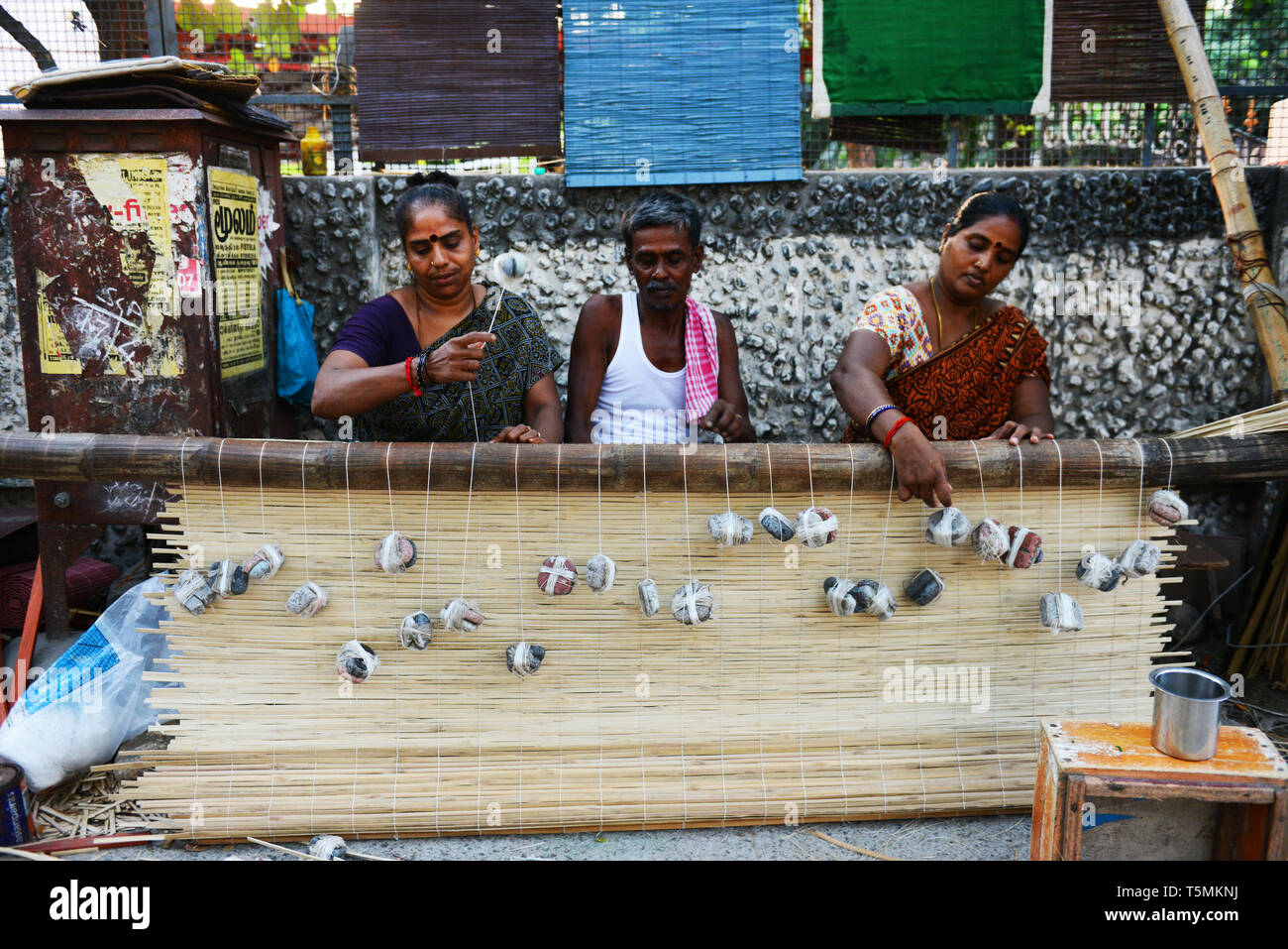 Tamil men and women working on a new bamboo curtain in the streets of Chennai. Stock Photo