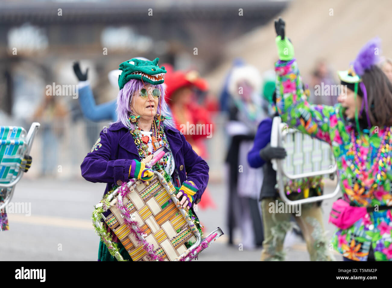 St. Louis, Missouri, USA - March 2, 2019: Bud Light Grand Parade, Women wearing colorful outfits and hats  perform a chair dance at the parade Stock Photo