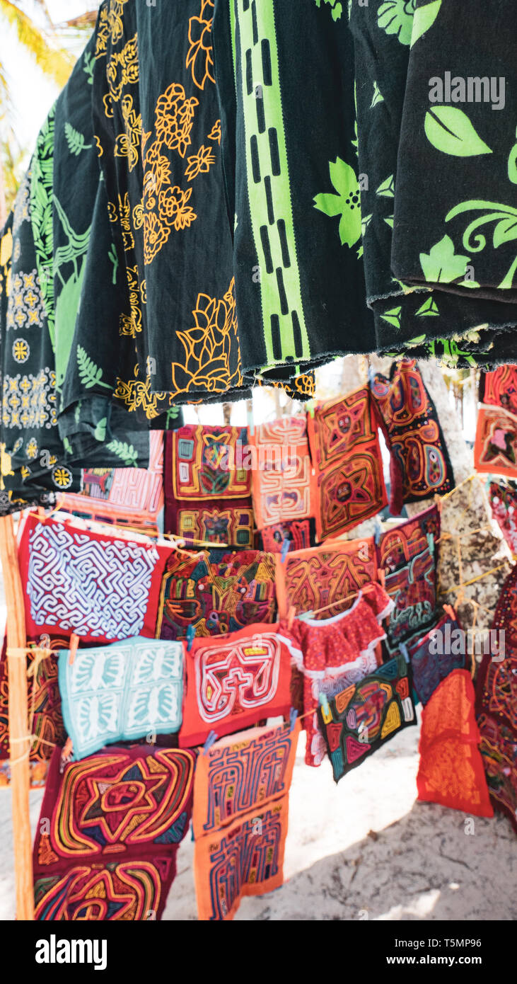 The women of the Guna (aka Kuna) tribe are the primary breadwinners, selling traditional Molas (colorful appliqué fabric pieces) to tourists Stock Photo