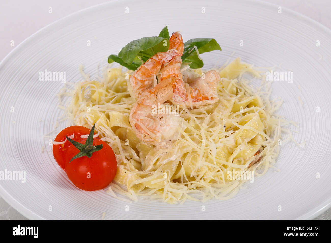 Italian pasta Linguini with prawns served basil Stock Photo
