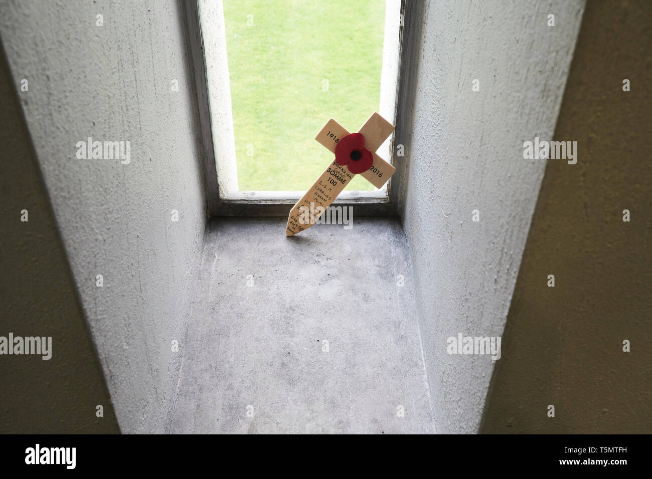 A remembrance cross for a fallen soldier at the Battle of the Somme placed inside one of the windows of the Guards' Chapel, London, UK. Stock Photo