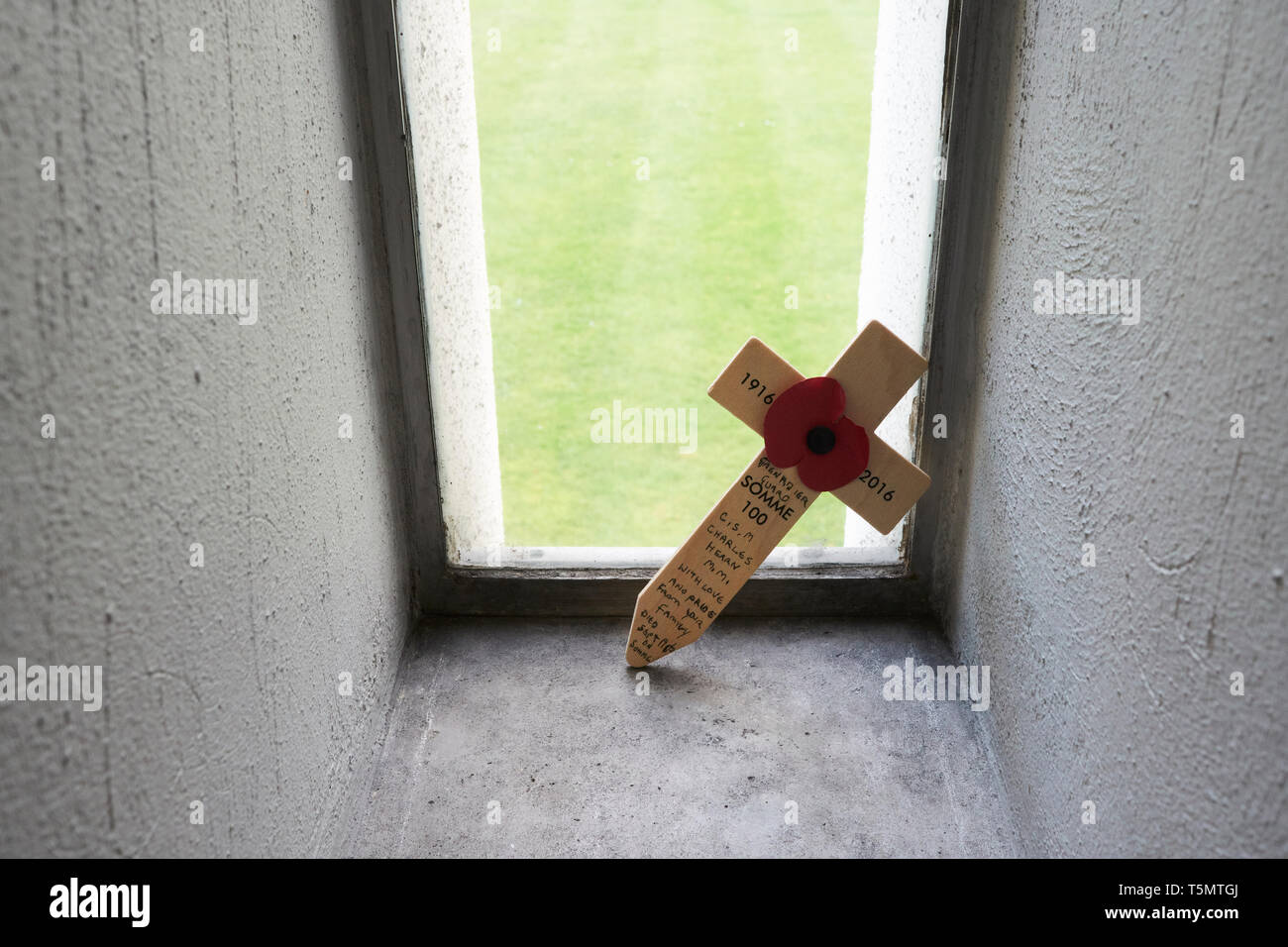 A remembrance cross for a fallen soldier at the Battle of the Somme placed inside one of the windows of the Guards' Chapel, London, UK. Stock Photo