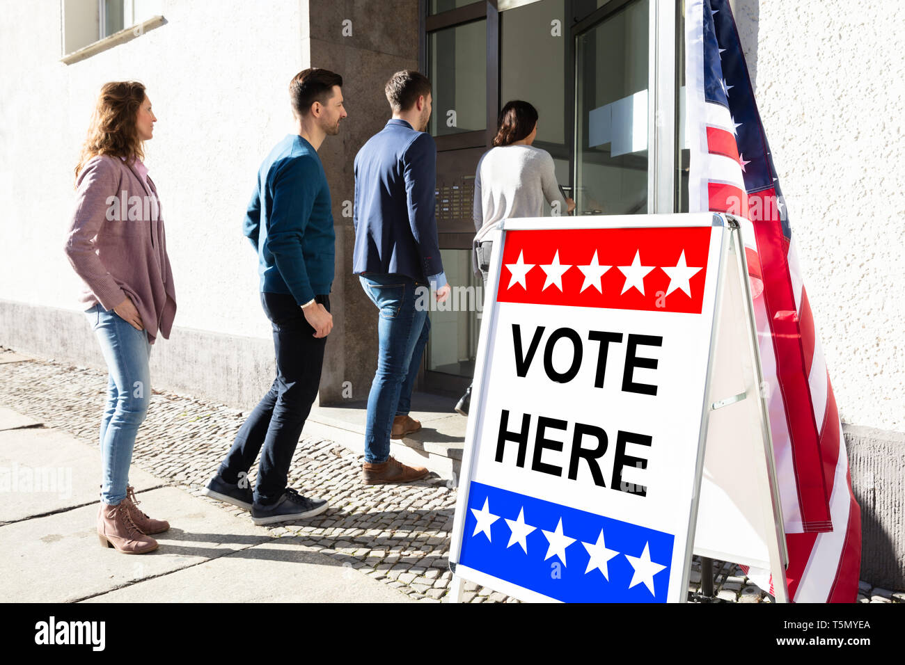 Group Of Young People Standing At The Entrance Of Voting Room Stock Photo
