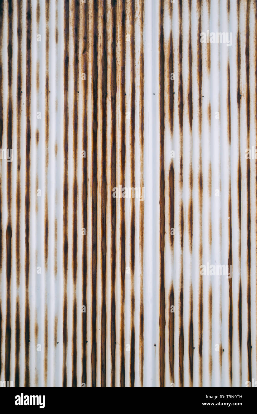 Old rusty wavy metal plate wall background Stock Photo
