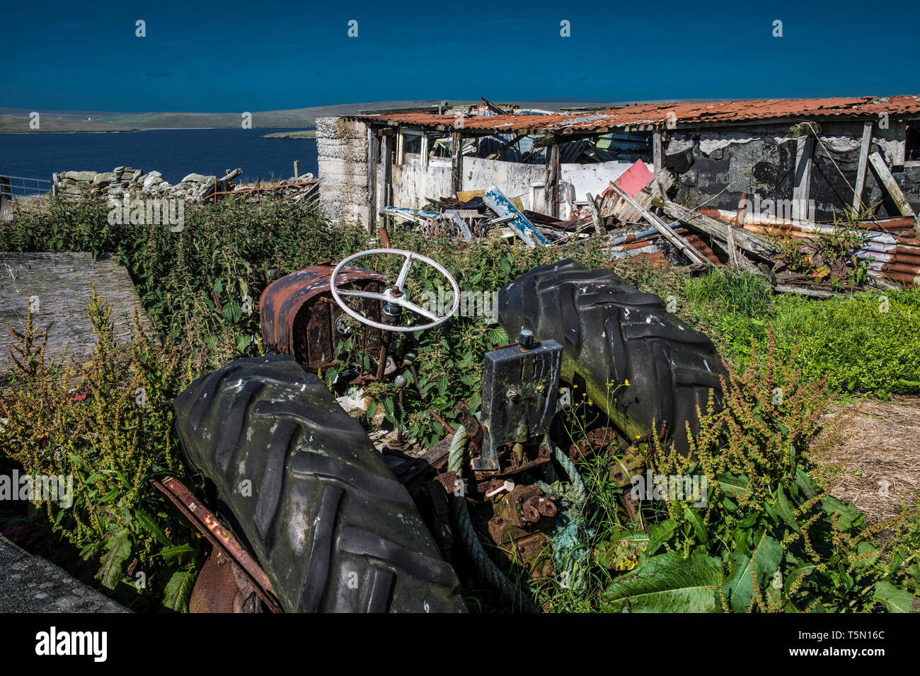 Tractor repairs and graveyard, haroldswick, Shetland Stock Photo