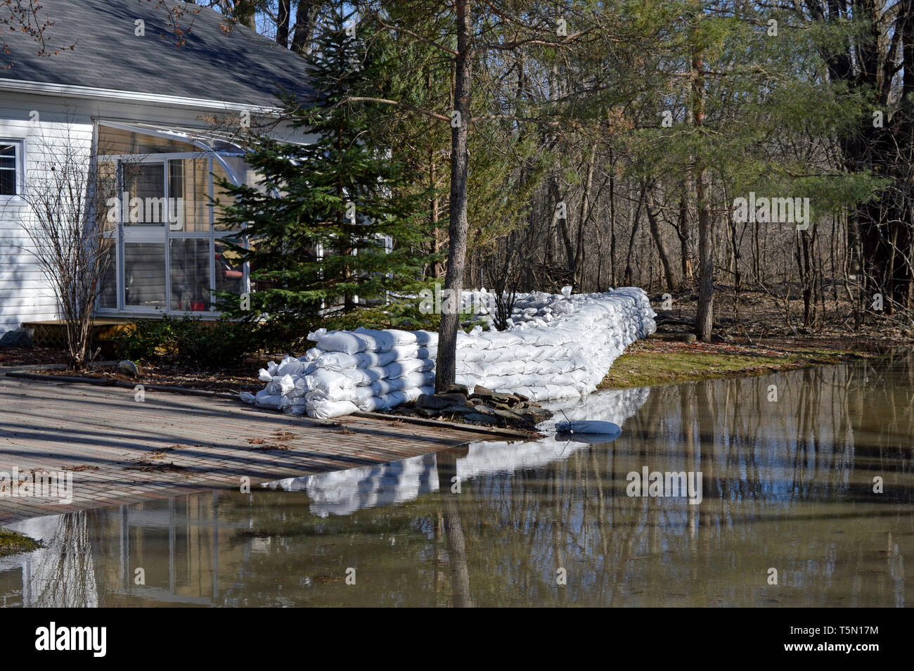 residents built a sandbag wall to protect their home from rising flood