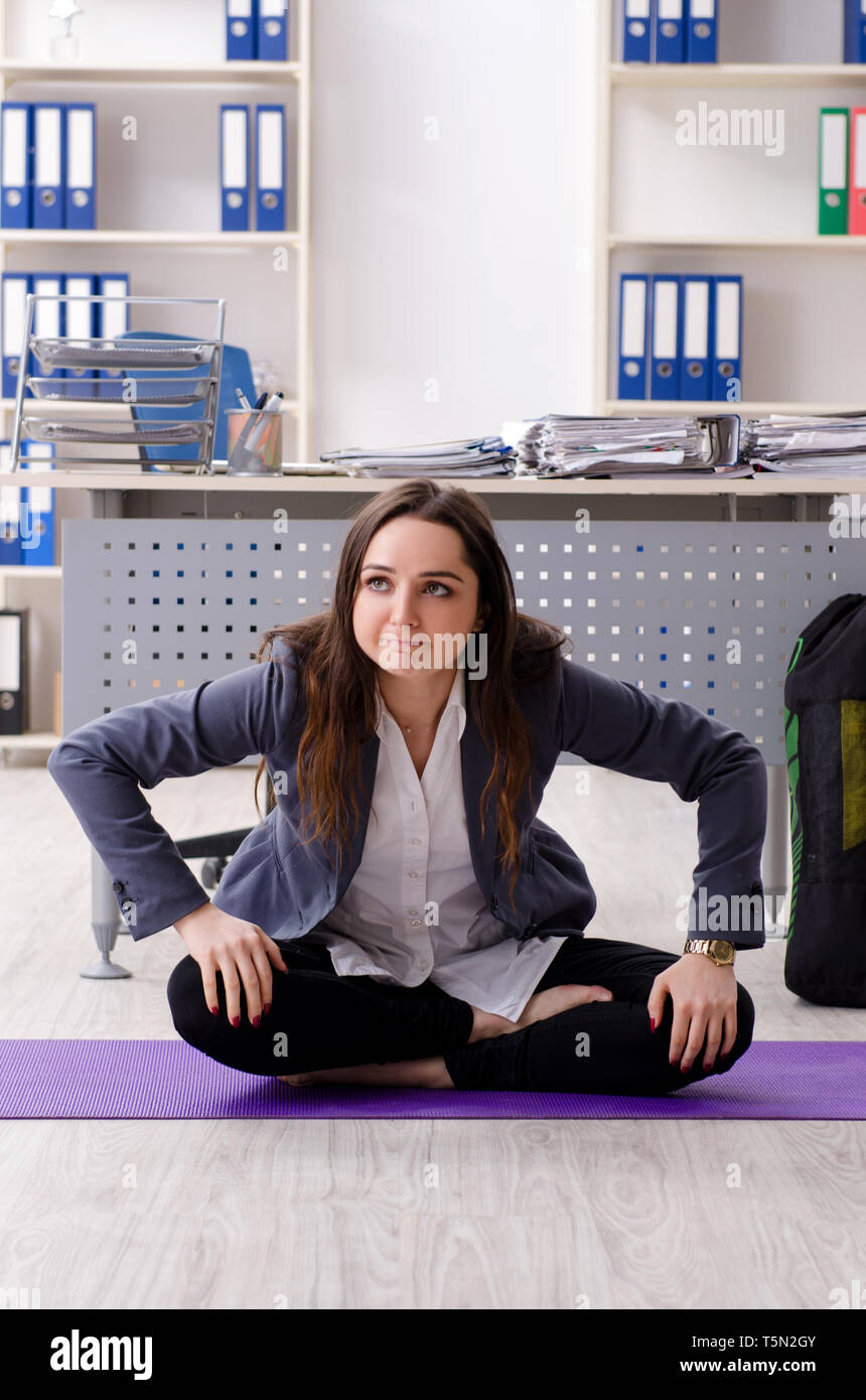 Female employee doing sport exercises in the office Stock Photo - Alamy