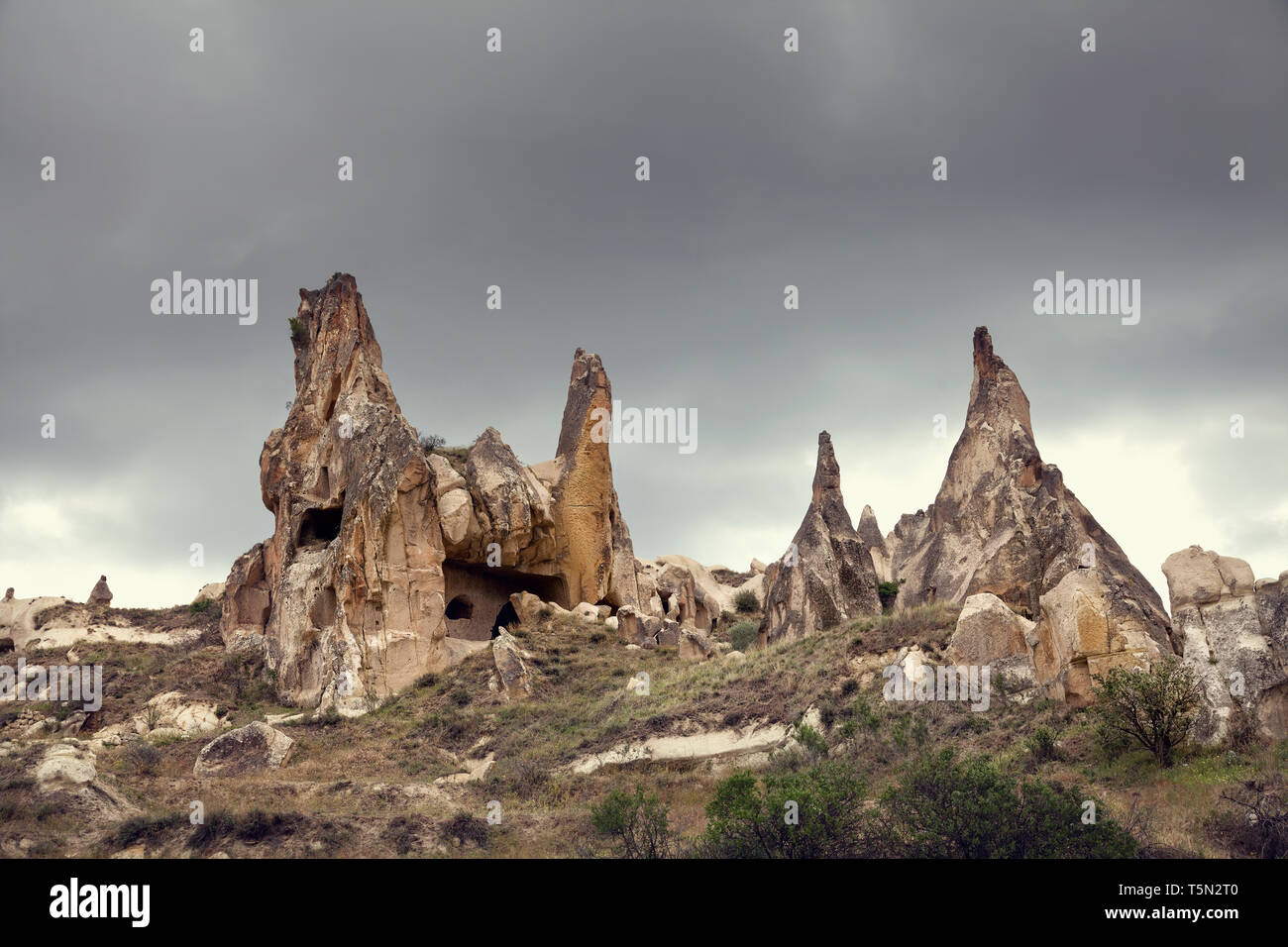 Rock formations at overcast sky in Goreme National Park in Cappadocia, Turkey Stock Photo