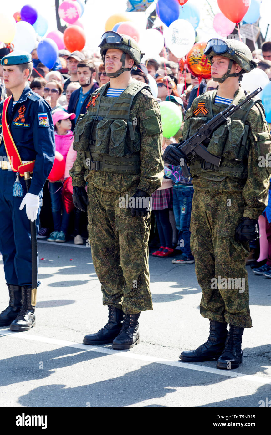 Russia, Nakhodka, 05/09/2017. Soldiers in combat camouflage with assault rifles AK-74 stay on parade on annual Victory Day on May 9. Honor of victory  Stock Photo