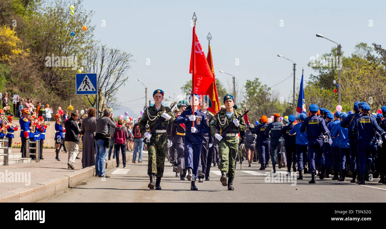 Russia, Nakhodka, 05/09/2017. Cadets in parade uniform with USSR's flag march on parade on annual Victory Day on May 9. Holiday in honor of victory of Stock Photo