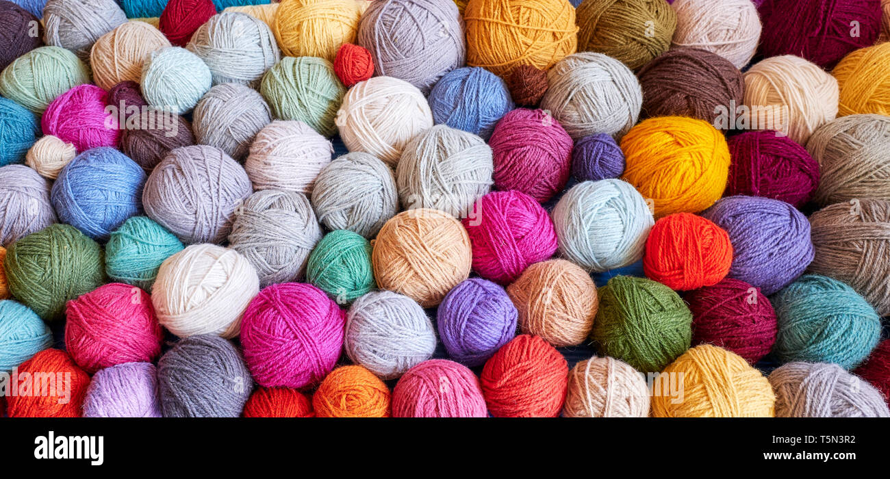 Colorful background made of many wool yarn balls. Stock Photo