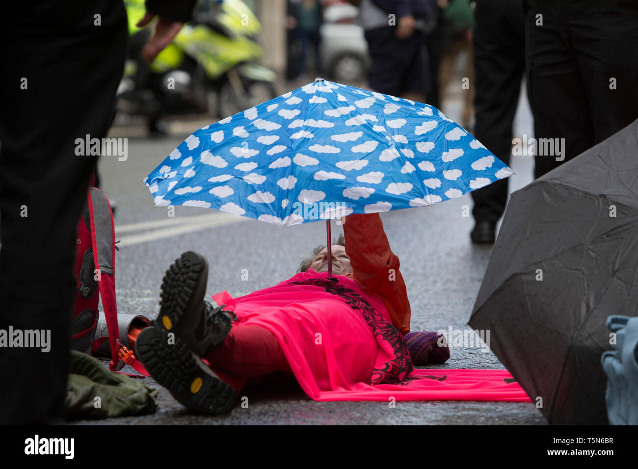Environmental protesters chain themselves together and glue body parts to the road in Fleet Street on the 11th and final day of protests, road-blockages and arrests across London by the climate change campaign Extinction Rebellion, on 25th April 2019, in London, England. Stock Photo