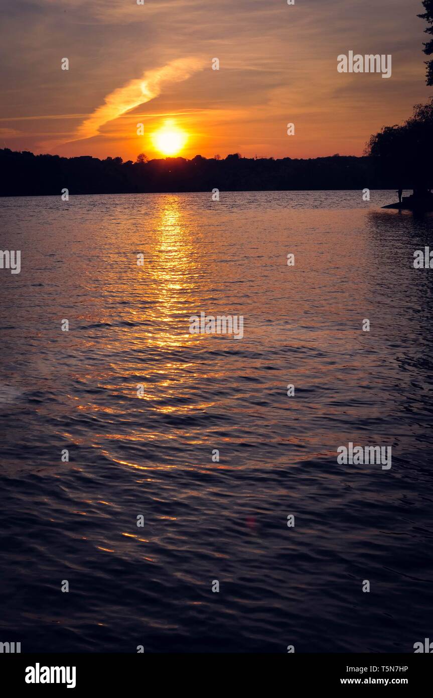 Sunset silhouette on the lake Stock Photo - Alamy