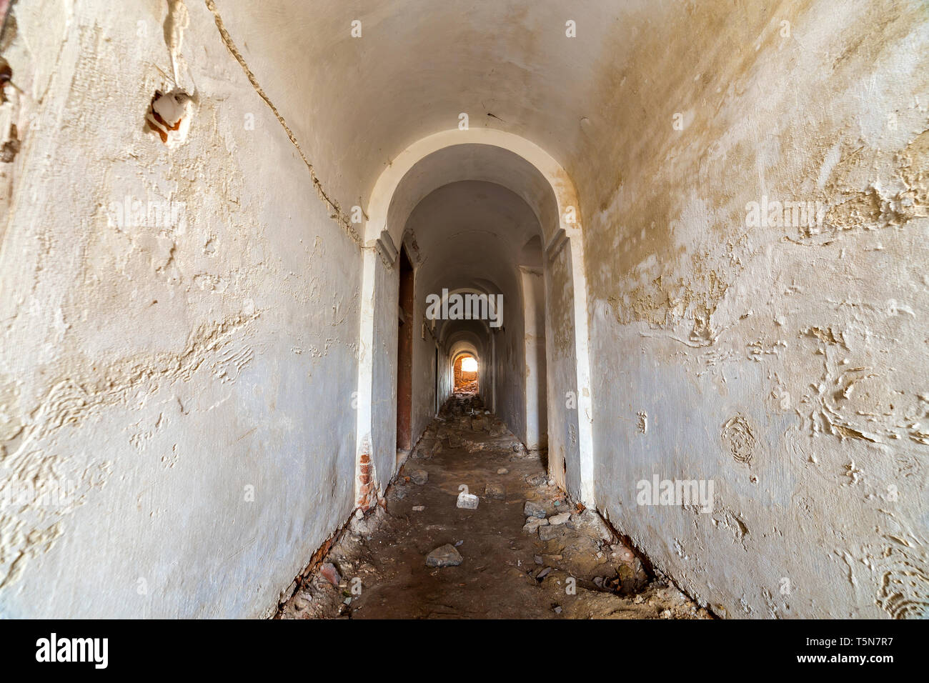 Basement of old fortress building, long narrow corridor with vaulted ...