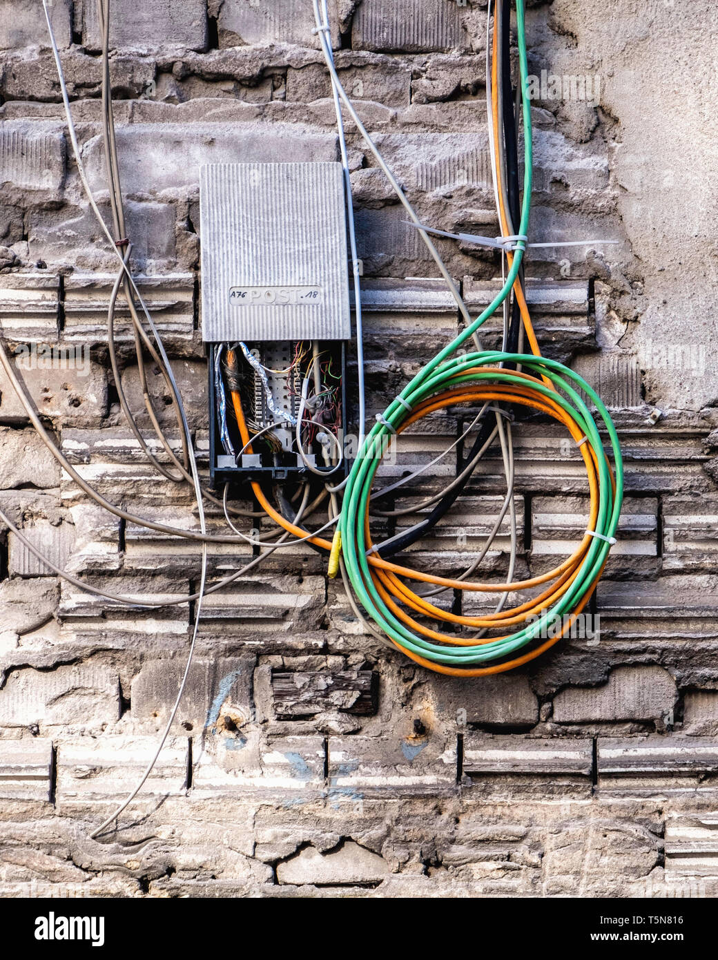 Wedding, Berlin.Electric wiring in Inner courtyard of dilapidated old industrial building next to Panke river at Gerichtstrasse 23.Building detail. Stock Photo