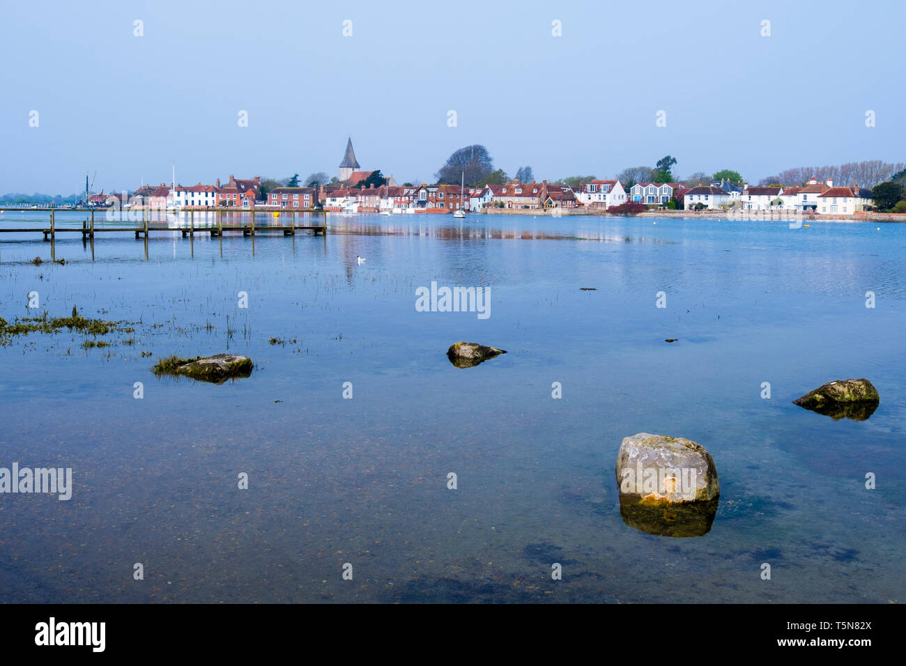 View to pretty old village across Bosham Creek at high tide in Chichester harbour. Bosham, West Sussex, England, UK, Britain Stock Photo