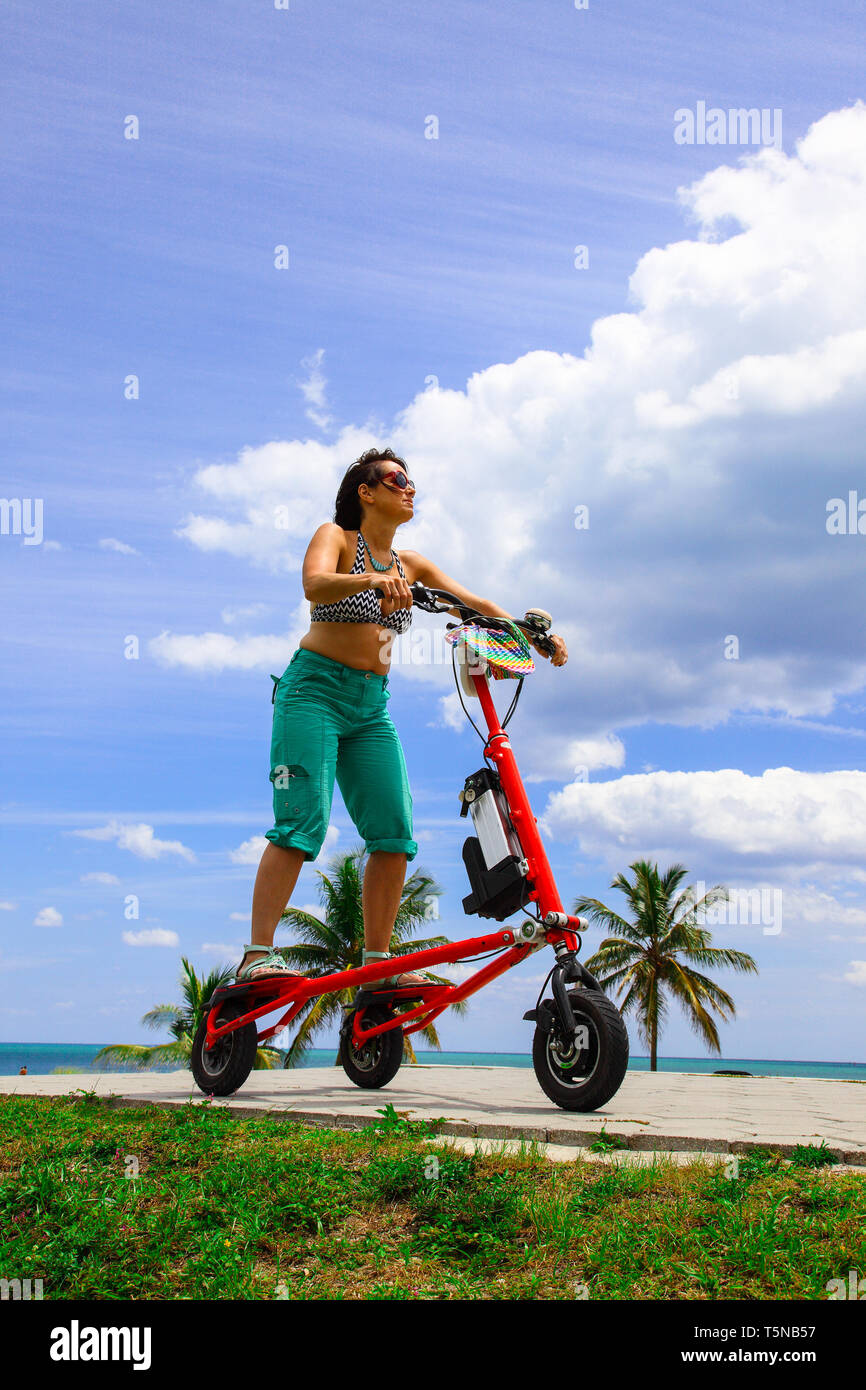 Woman on an electric tricycle in Miami Stock Photo