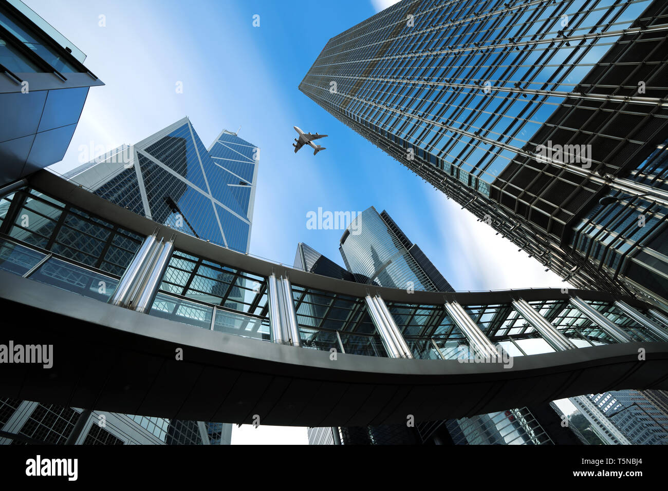 Modern business center in Hongkong. Skyscrapers in commercial area with airplane flying above at Hongkong. Asia Stock Photo