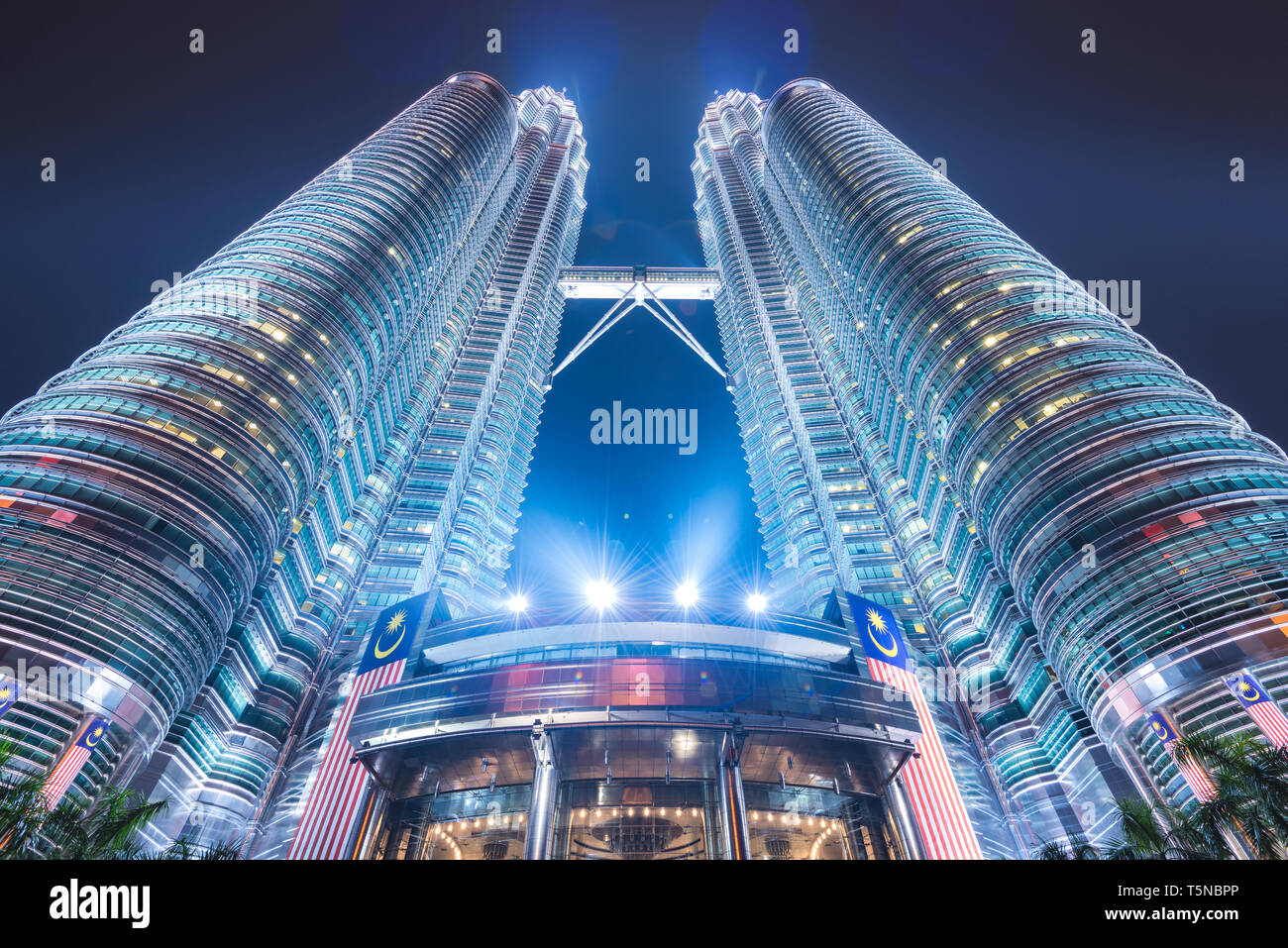 KUALA LUMPUR - SEPTEMBER 16, 2015: The Petronas Towers viewed from below at night. Stock Photo