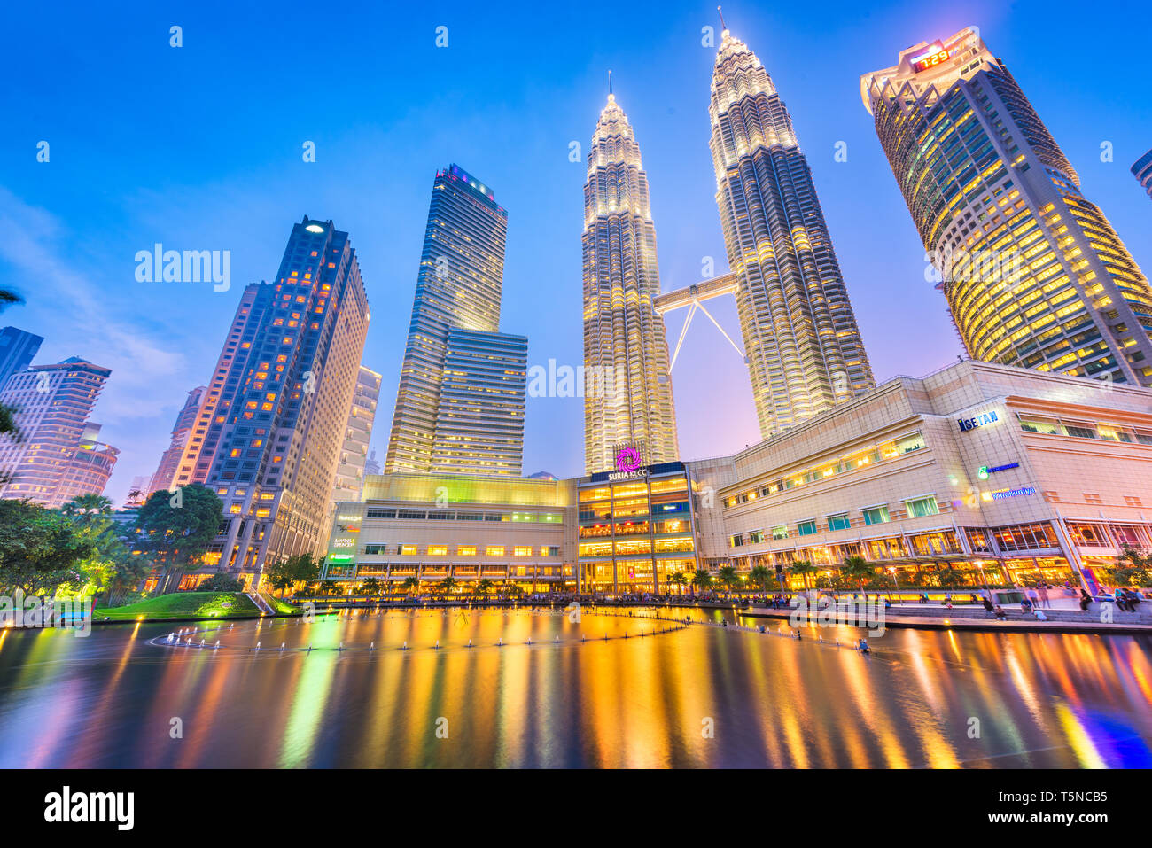 KUALA LUMPUR - SEPTEMBER 14, 2015: The Petronas Towers viewed from KLCC Park at twilight. Stock Photo