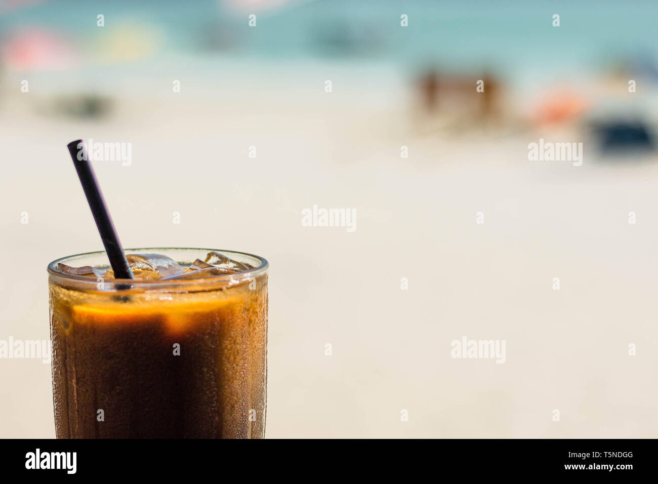 Iced coffee in front of the beach Stock Photo